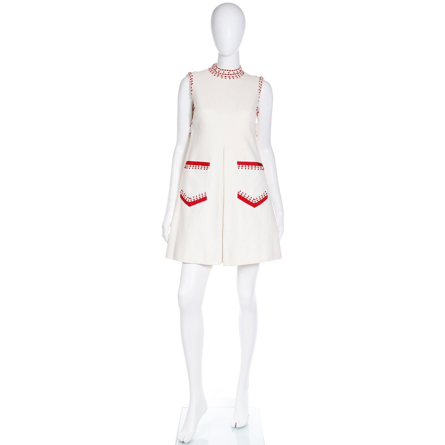 We love vintage Oscar de la Renta dresses, and this sleeveless vintage Oscar de la Renta mini dress is a rare piece he designed in the 1960's. This cotton pique Oscar de la Renta Boutique baby doll style dress has pretty faceted red beads and cherry