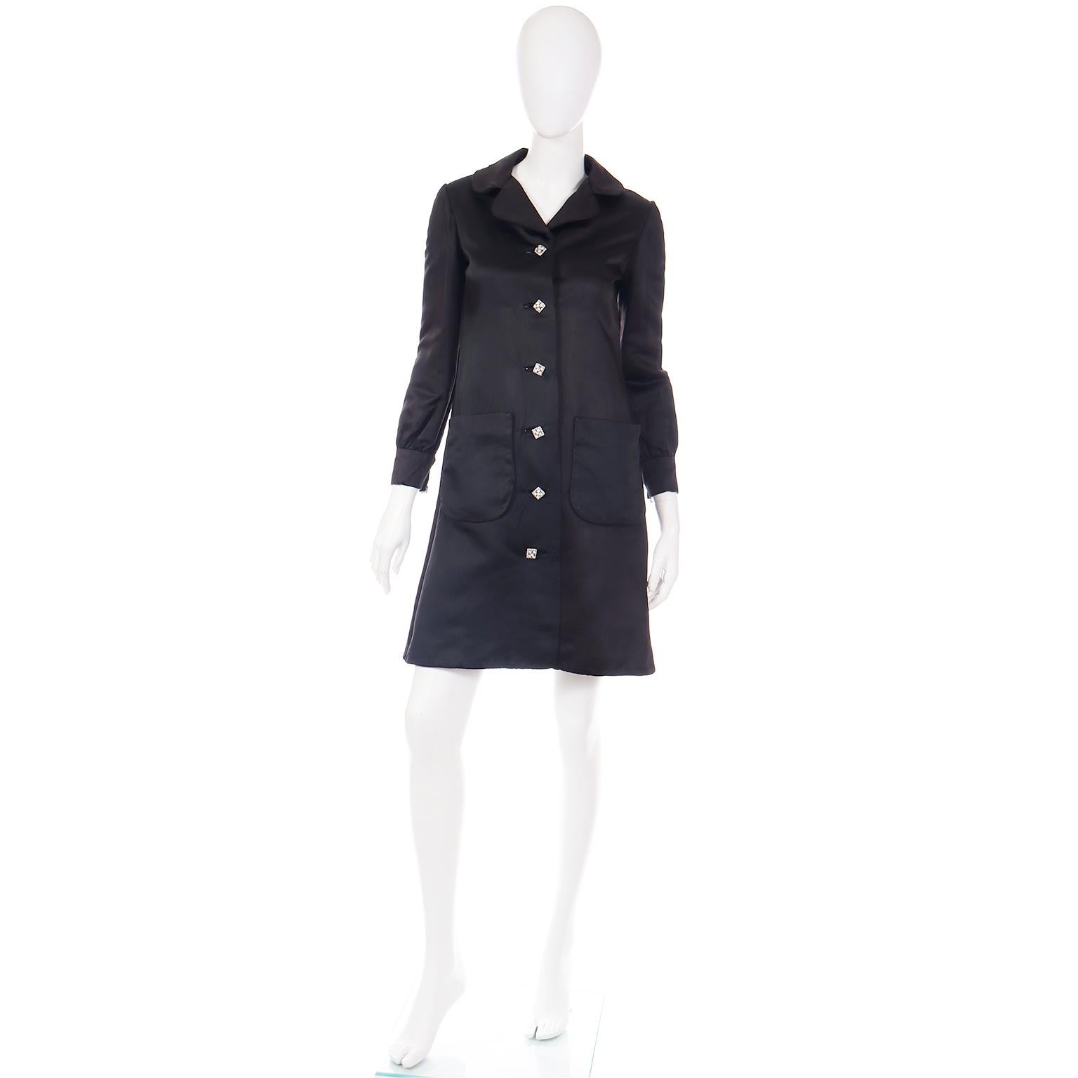 We love finding vintage Oscar de la Renta pieces and we fell in love with this gorgeous 1960's evening coat instantly! This lovely black satin coat has front patch pockets and beautiful square silver buttons set with rhinestones. The coat is fully