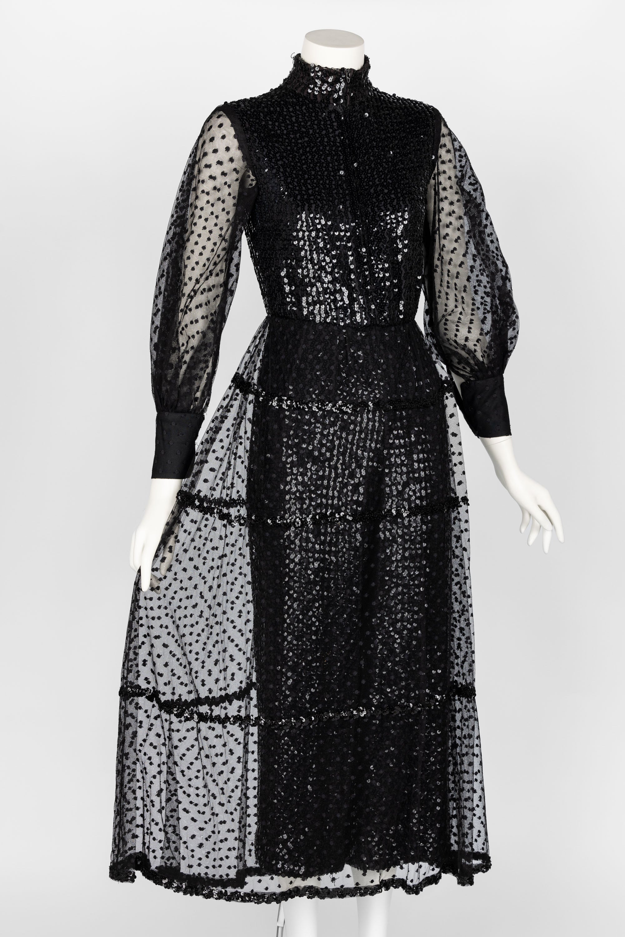 This 1960s Oscar de la Renta sequin jumpsuit is a dazzling embodiment of vintage glamour. The piece is fully adorned with shimmering black sequins, creating a striking play of light and texture that captivates from every angle. The semi-sheer
