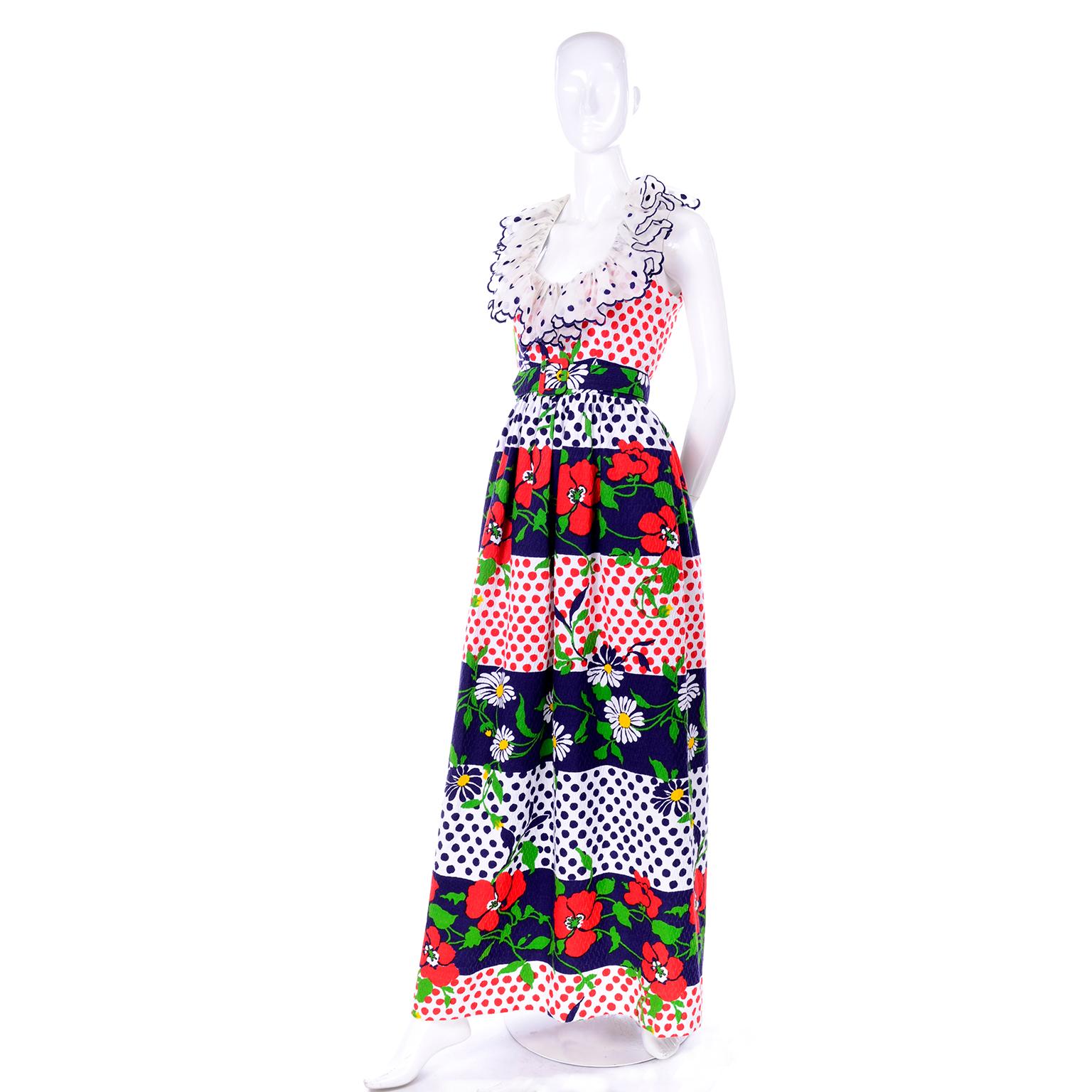 This is the perfect summer dress by Oscar de la Renta from the late 1960's! It is a sleeveless maxi dress with dramatic sheer ruffles around the collar with blue embroidered polka dots. The dress is made of a textured cotton with bands of red, white