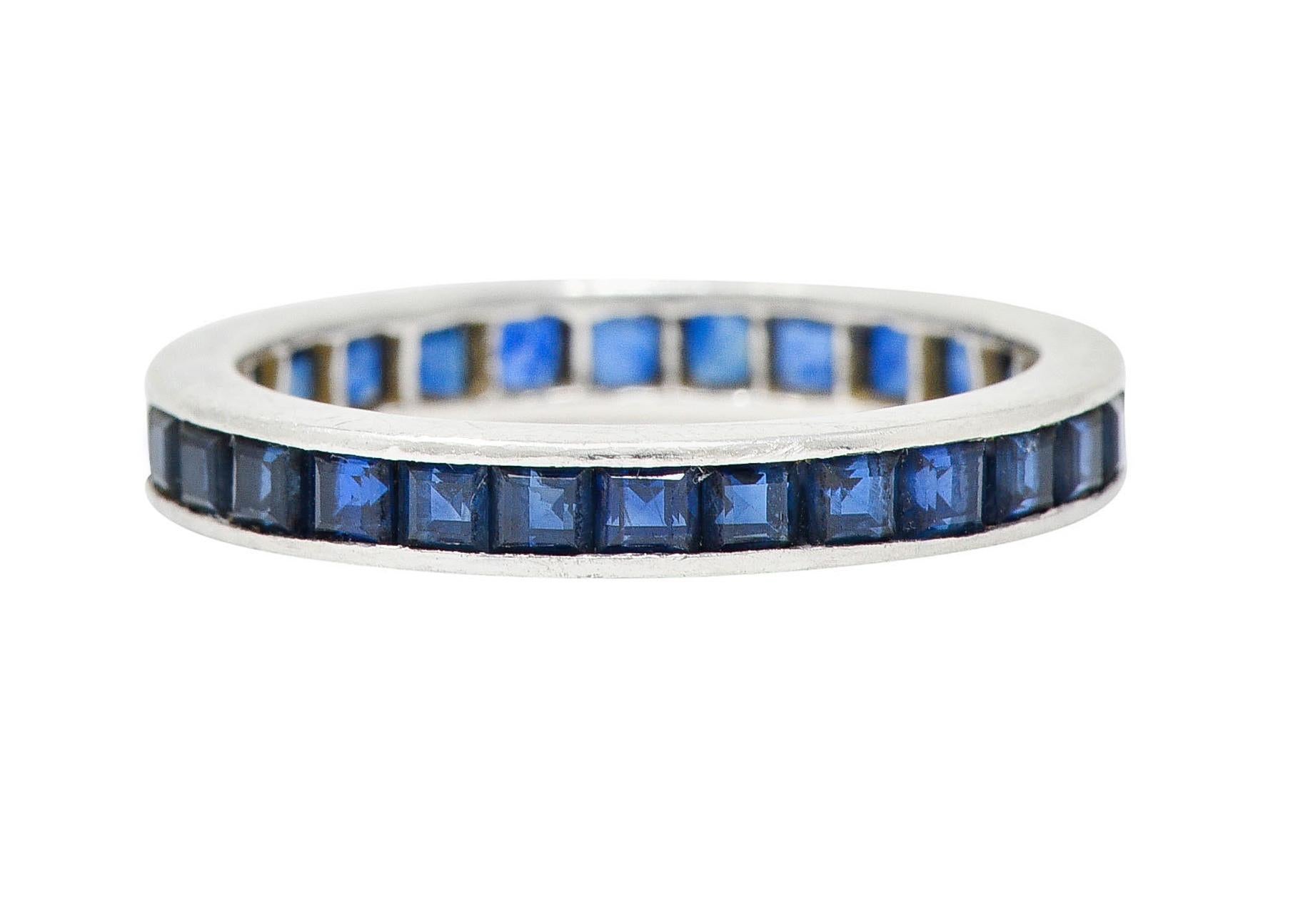 Eternity band ring is channel set fully around with square cut sapphires

Weighing in total approximately 2.00 carats with very well matched royal blue color

Completed by polished channel walls

Stamped PLAT for platinum

Numbered with maker's mark