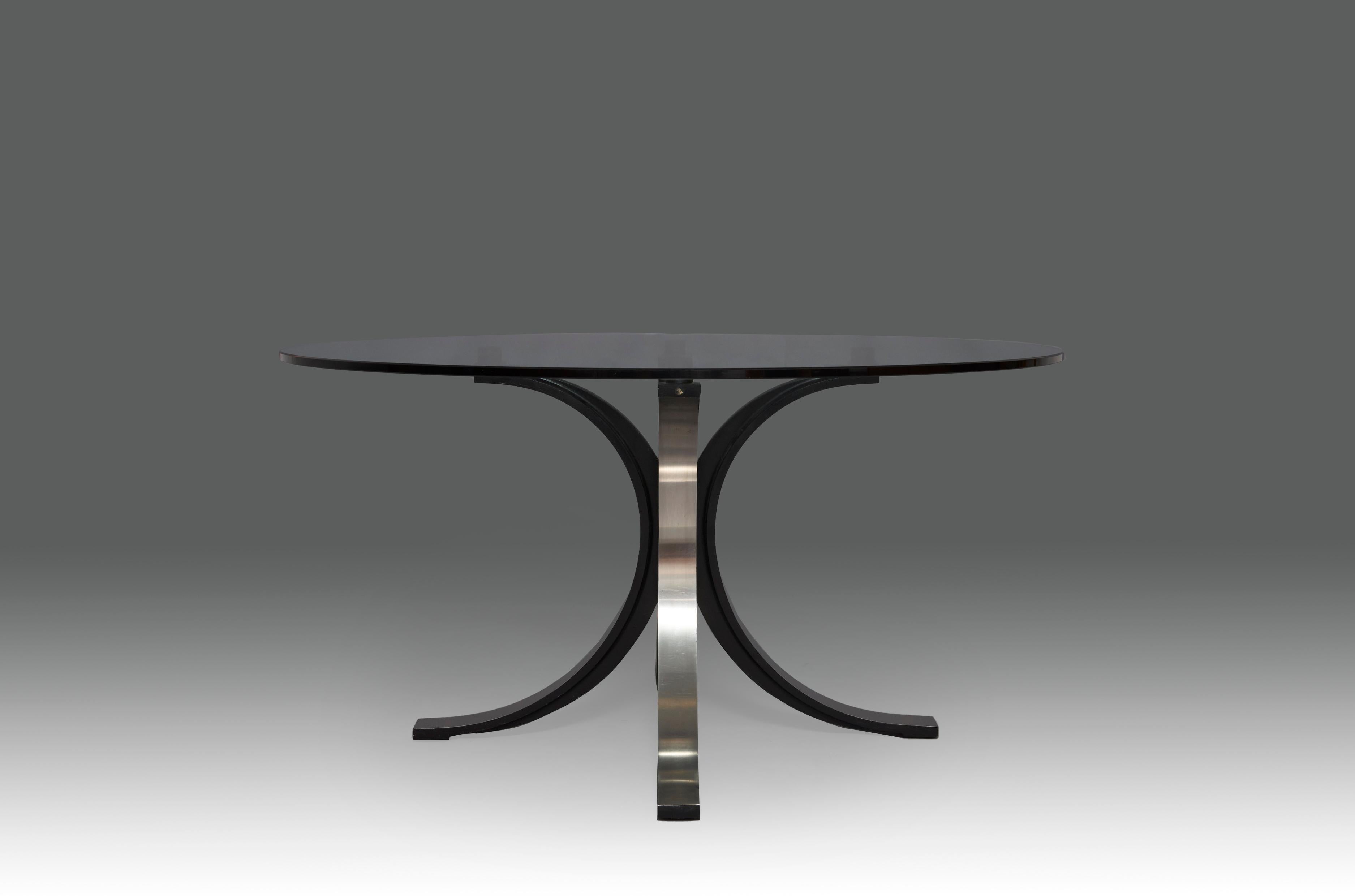 Dining table designed by Osvaldo Borsani & Eugenio Gerli for TECNO. Italy, 1960s. Matte-black laquered cast aluminum with brush steel foil and glass table top. In an excellent condition. 

Osvaldo Borsani was an Italian architect and designer who