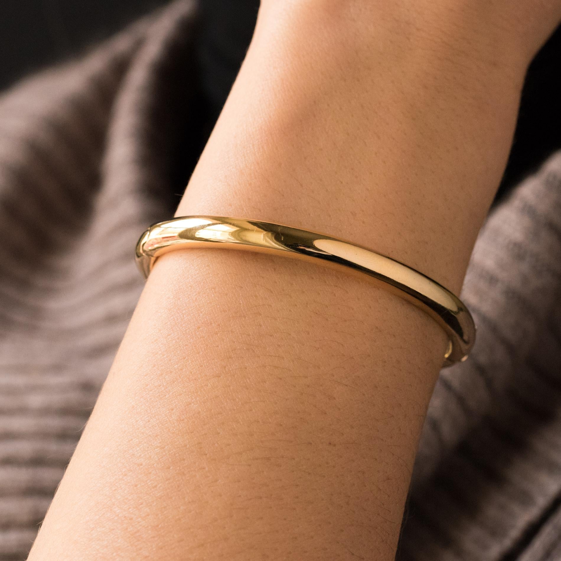 Bracelet in 18 karat yellow gold.
Oval-shaped half-bangle bracelet, it can be opened on one side using a hinge. The clasp is ratchet with a safety 8.
Wirst circumference : 16 cm, largest inside diameter: 6.9 cm, width: 5.6 mm, thickness: 4.3