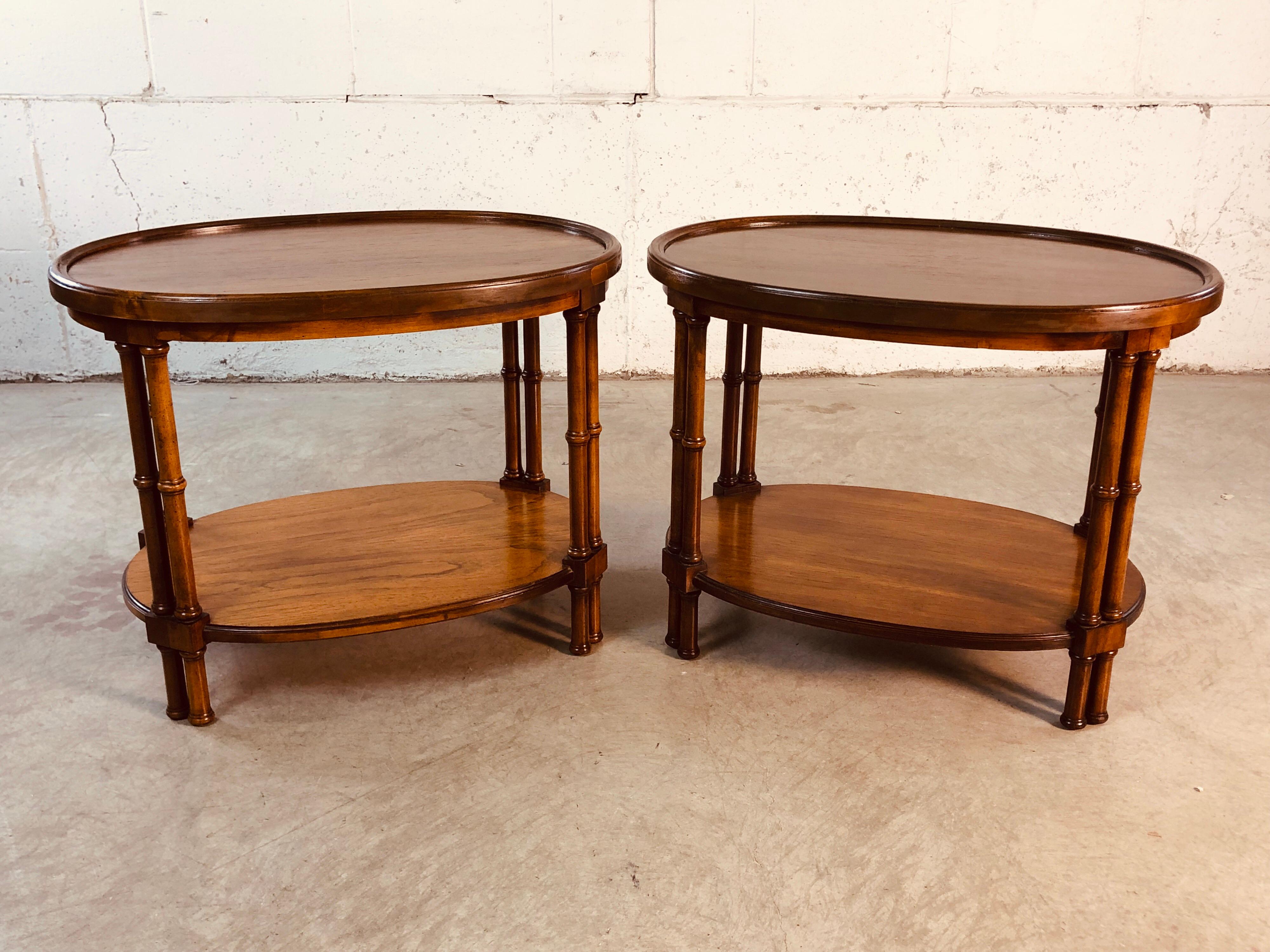 Vintage 1960s pair of Brandt Furniture mahogany oval bamboo style side tables. The tables have an additional shelf for storage. They have been completely restored and refinished. Marked underneath.