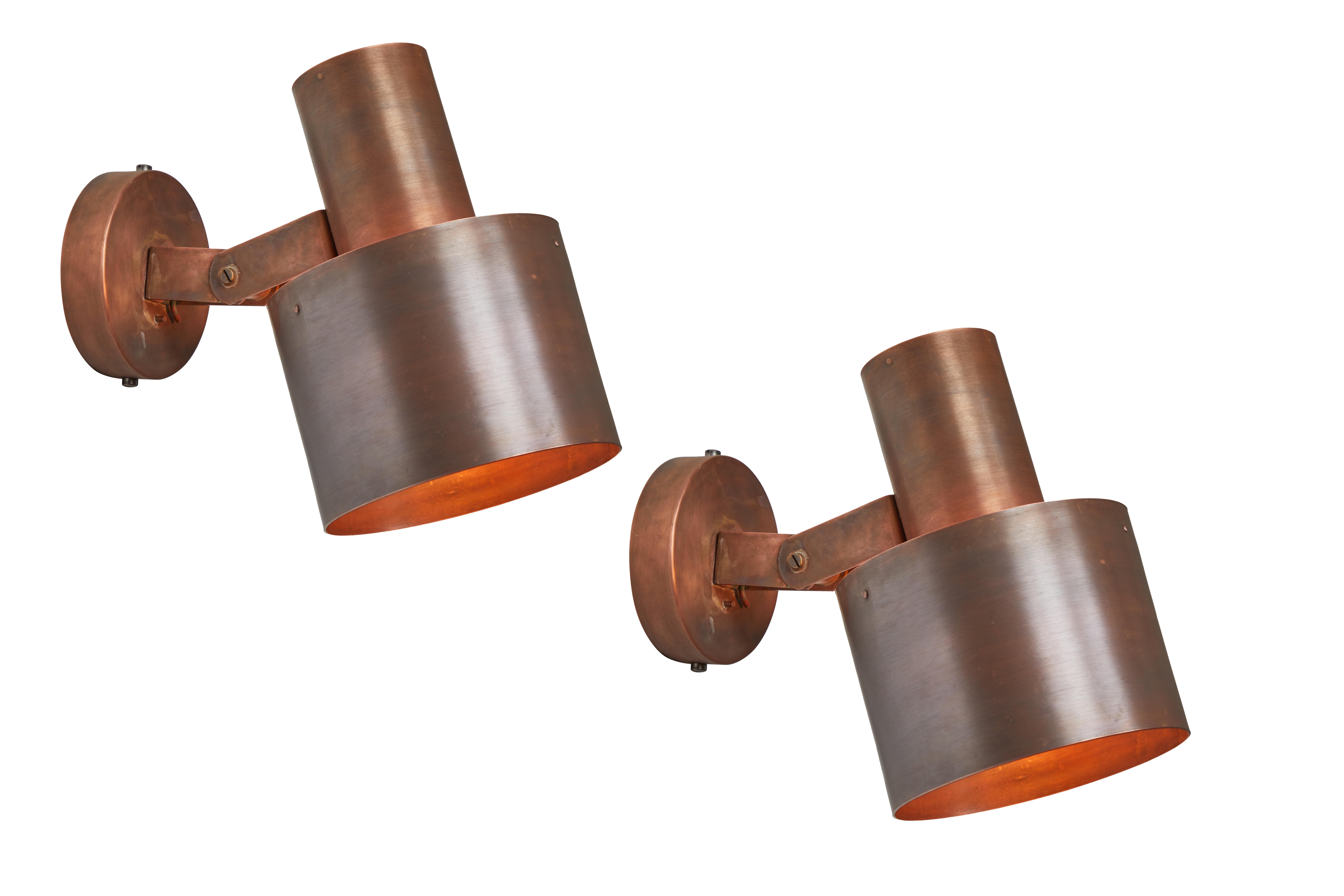 1960s Paavo Tynell Copper wall lamps for Idman Oy. These rare and exceptionally refined wall lights are executed in a rich and attractively patinated copper. Signed with manufacturer's mark to back shade of each example, Finland, circa 1960s. Shade