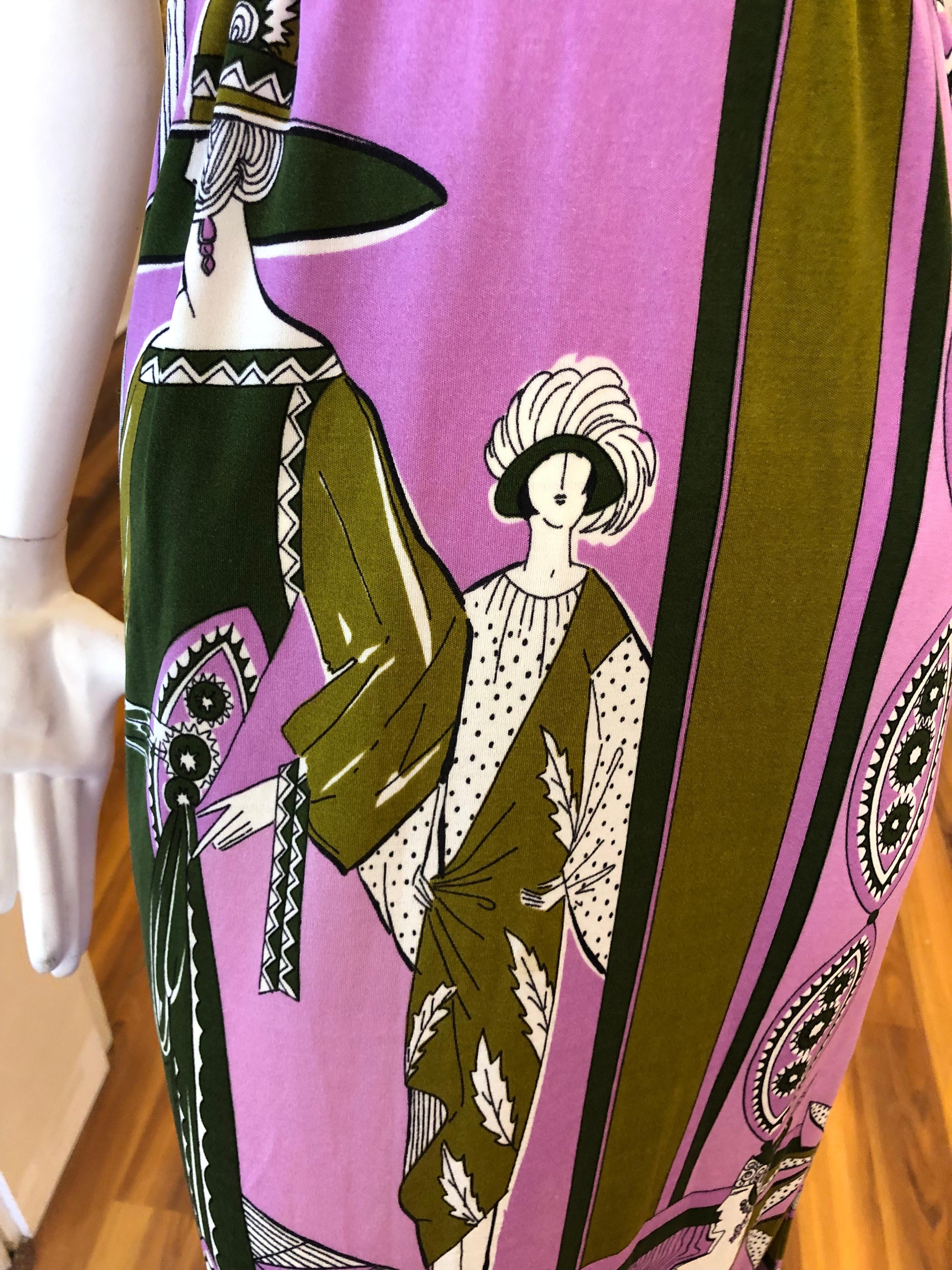 Amazing long dress in excellent Condition. The main graphics feature Art Nouveau fashion. The dress features a high neck; a band below the bust, and a side vent. The colors are predominantly mauve, olive green, and pink.