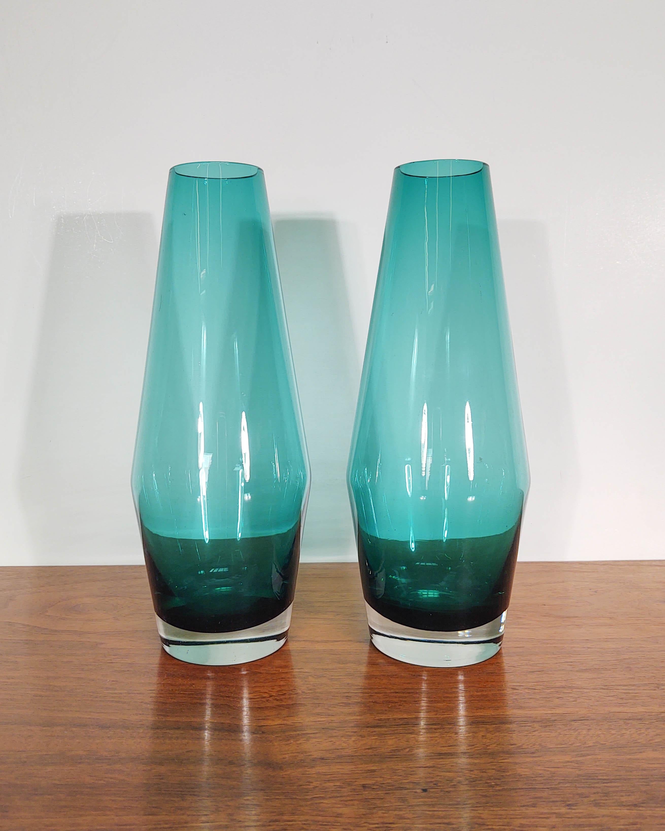 A beautiful matching pair of handmade glass vases by Tamara Aladin for Riihimäen Lasi. The lines of this vase are simple and beautiful. Clear thick glass as a base makes for a sturdy vase that doesn't tip over easily. This is a blown art vase