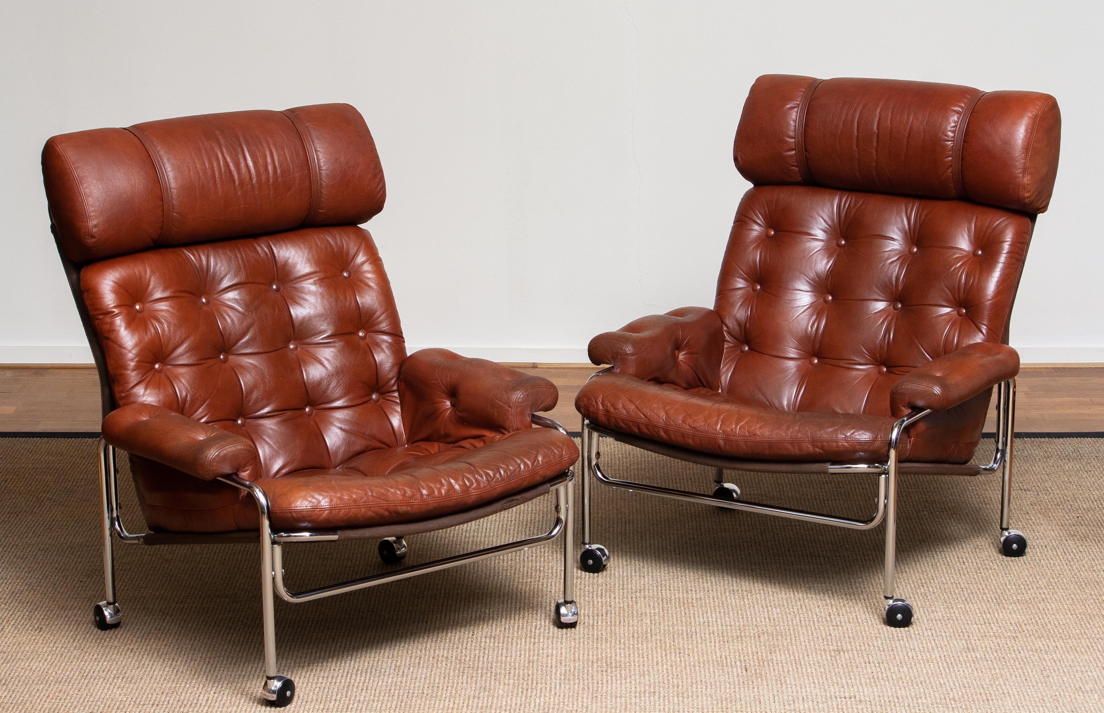 Beautiful set of two lounge / easy chair in aged brown / cognac leather and chrome designed by Pethrus Lindlöfs for A.B. Lindlöfs Möbler Lammhult, Sweden. 
The aged leather on both chairs gives them there typical vintage character. The leather is