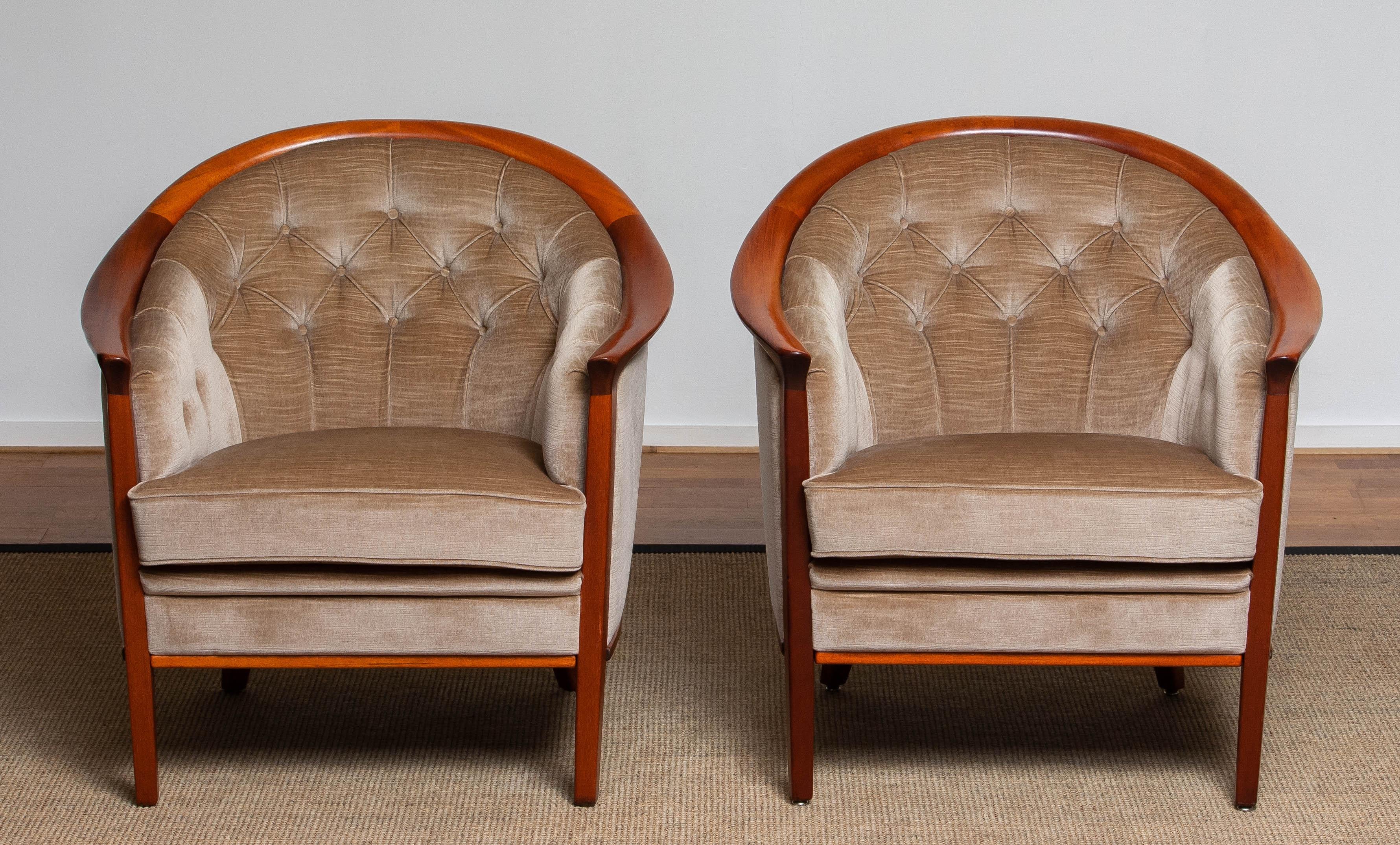 Beautiful set of two Scandinavian 'model Aristokrat' mahogany and padded taupe velvet lounge chairs designed by Bertil Fridhagen for Broderna Andersson / Broderna Anderssons Industrier Ekenässjön AB Sweden.
These high quality lounge chairs are