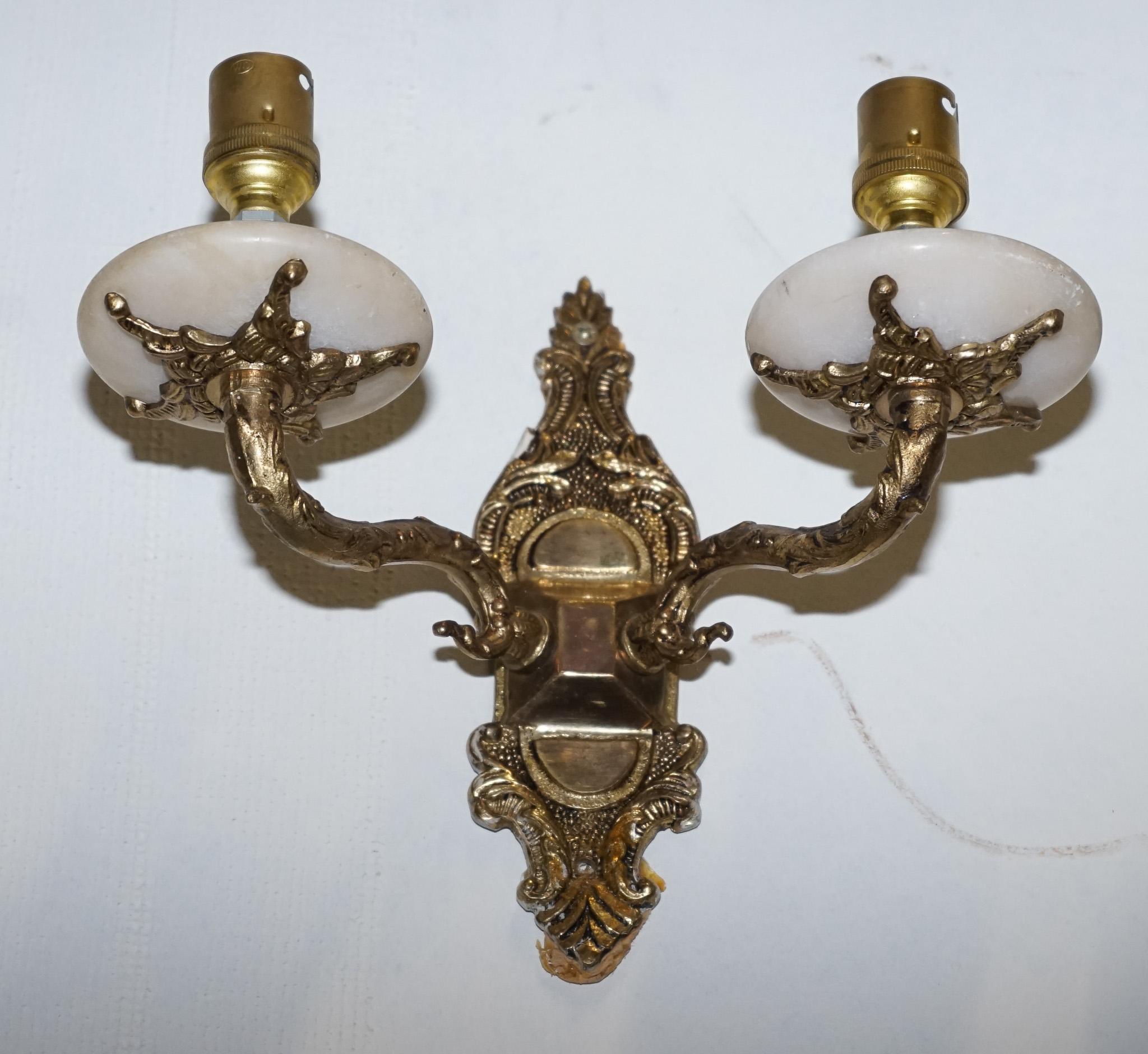 
Antiques of London



We are delighted to offer for sale this Pair Of 1960s Twin Wall Lights.

They offer a sophisticated blend of natural beauty and mid-century modern design. Crafted from alabaster and brass, these sconces exude a warm, inviting