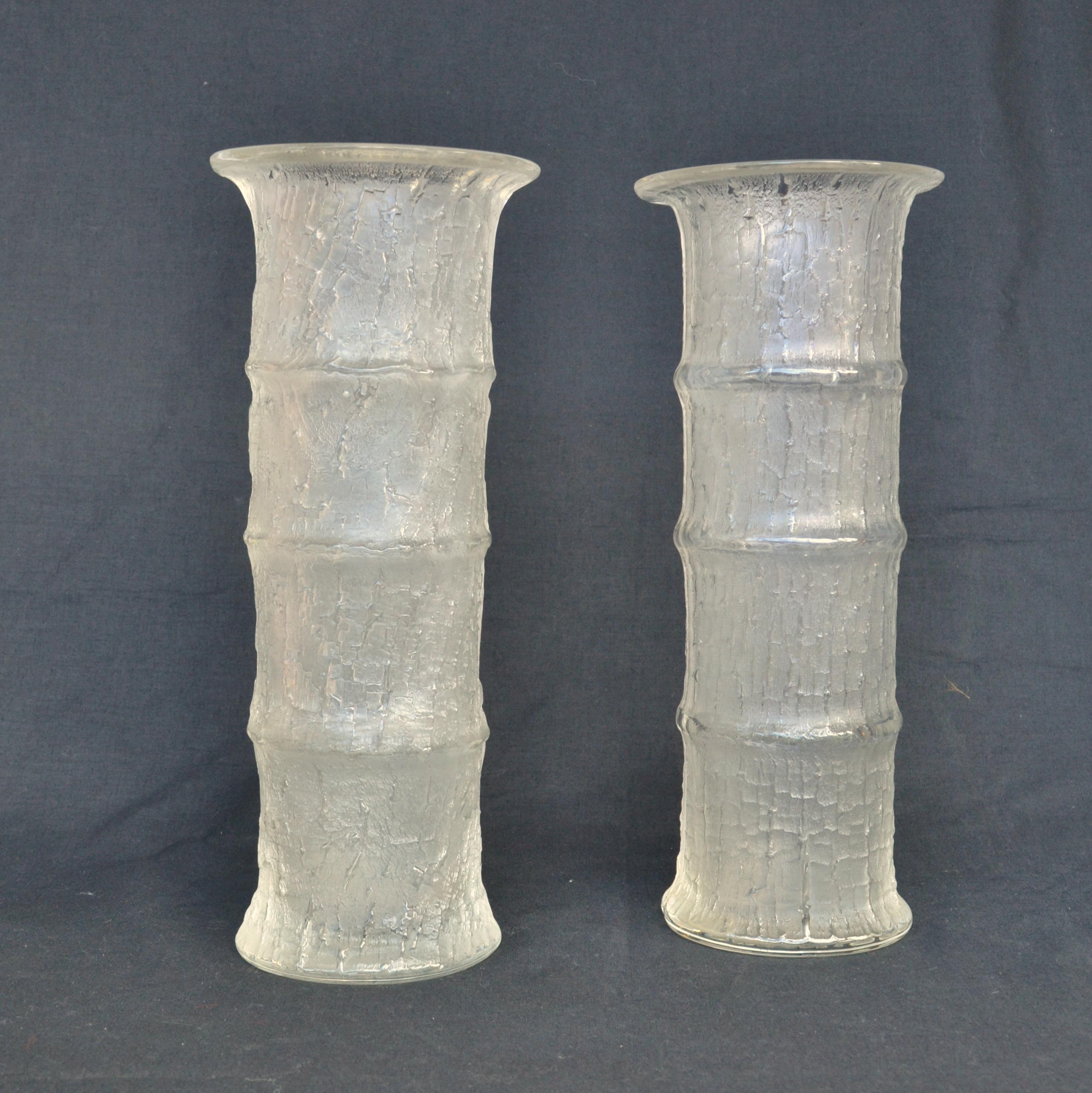 A pair of hand blown glass vases designed in 1964 by Timo Sarpaneva (1926-2006) for Iittala, Finland. Textured glass outside with a bamboo design is achieved by mold-blown technique creating a contrast of smooth glass on the inside and iced glass on