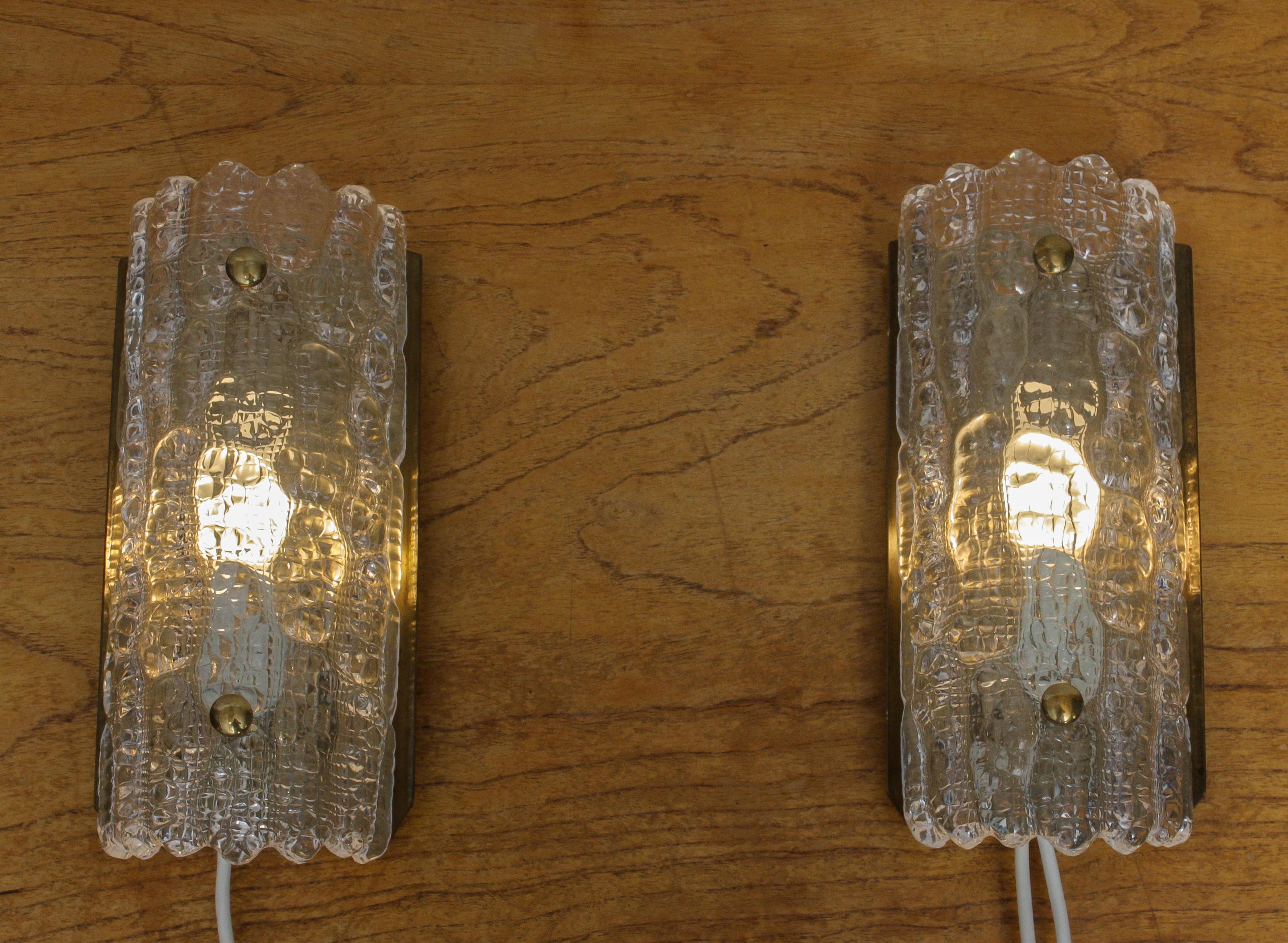 Set of two beautiful scones / wall lights designed by Carl Fagerlund for Orrefors, Sweden, 1960s.
Both scones are in perfect condition. Suits E14 / E17 bulbs for 110 / 230 volts.
Measurements are:
Height 30cm / 12 inch
Wide 12 cm / 5 inch.