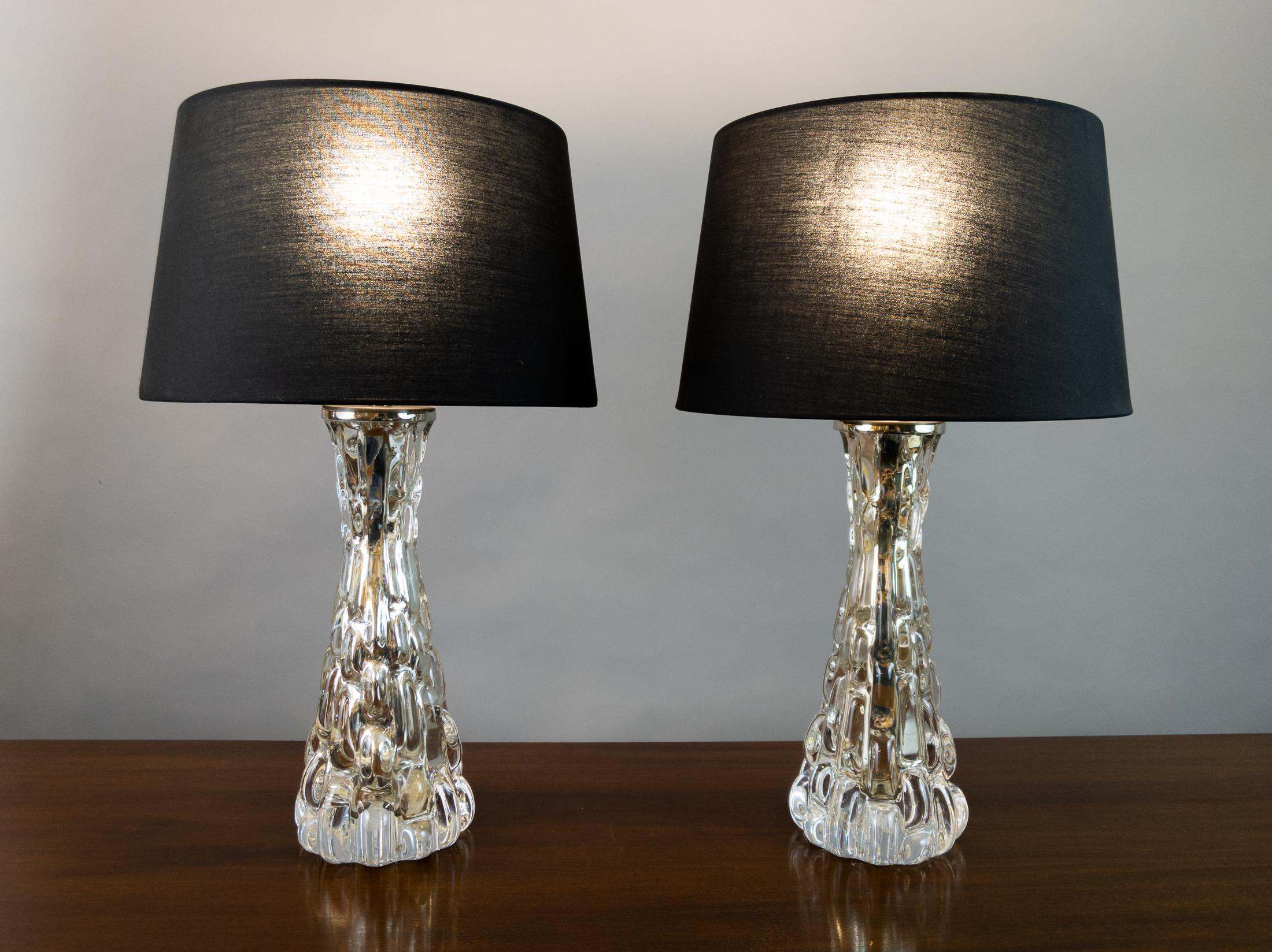 Pair of 1950s croco relief glass table lamps manufactured by Orrefors and designed by Carl Fagerlund, Sweden.  The lamps are created from molded glass with chrome rods which run through the centre of each light to conceal the flex. The internal rod