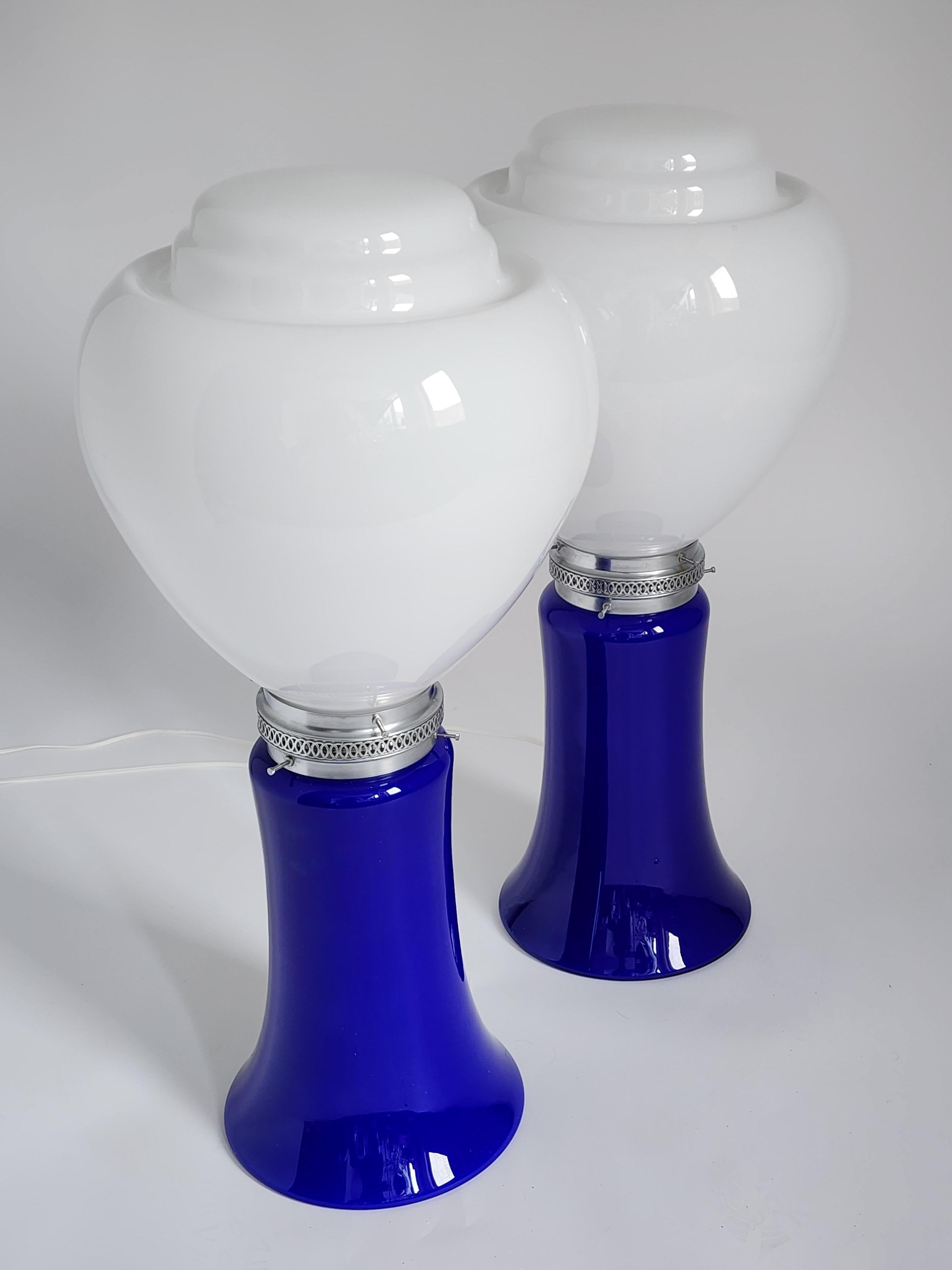 Massive Carlo Nason table lamp for Mazzega with an opaline shade sitting on a Cobalt blue base. 

Total height 28 in. Shade Measure 13.75 in wide by 14.75 high. 

Each lamp contain two E26 Size socket rated at 60 watt . One bulb in top shade the