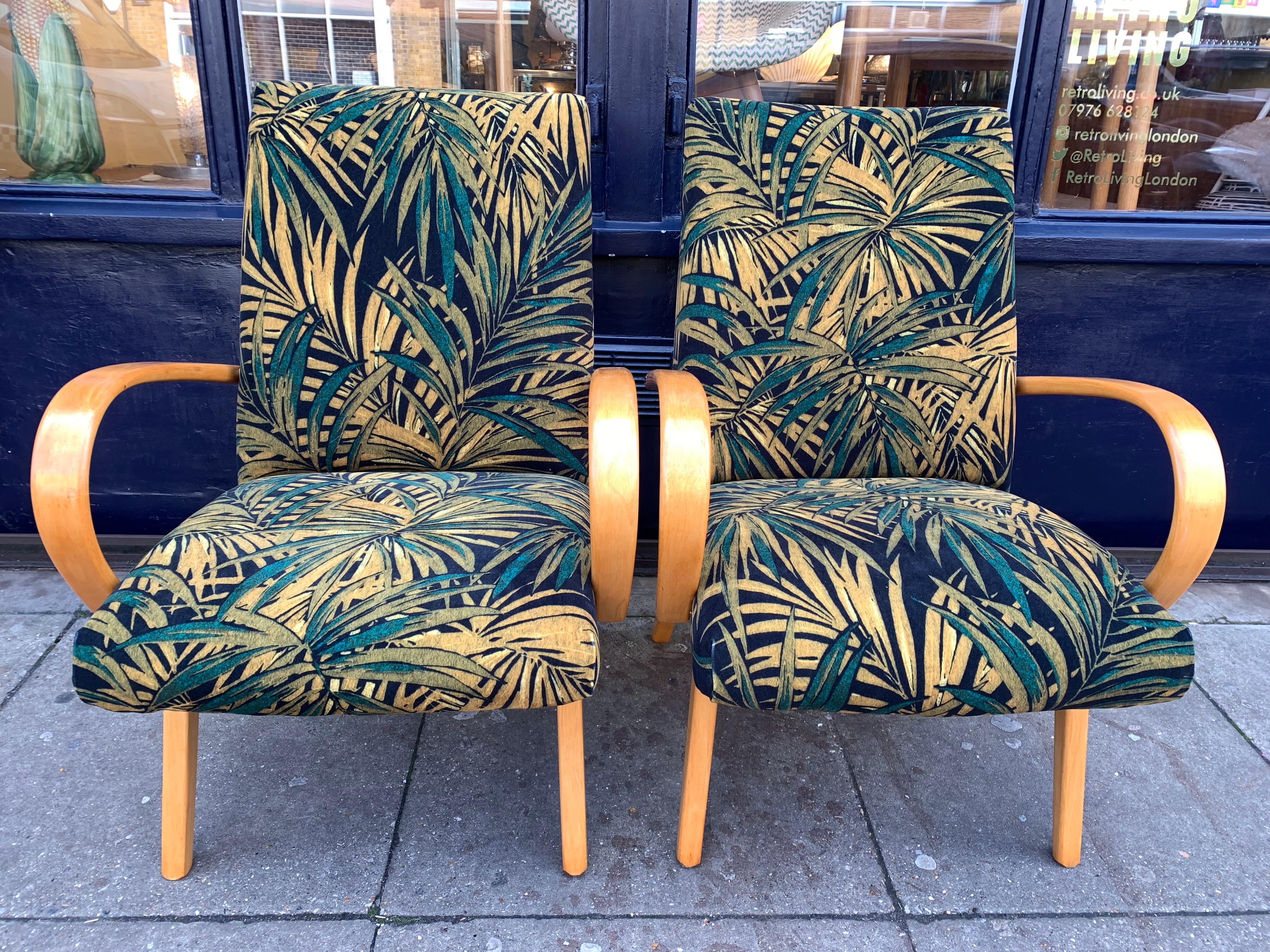 1960s pair of Czech armchairs by Jaroslav Smidek for Ton Factory. Beautifully restored and reupholstered in contrasting green palm fabric from Linwood Fabrics. The frames are made from Purified beech which contrast and highlight the colours and