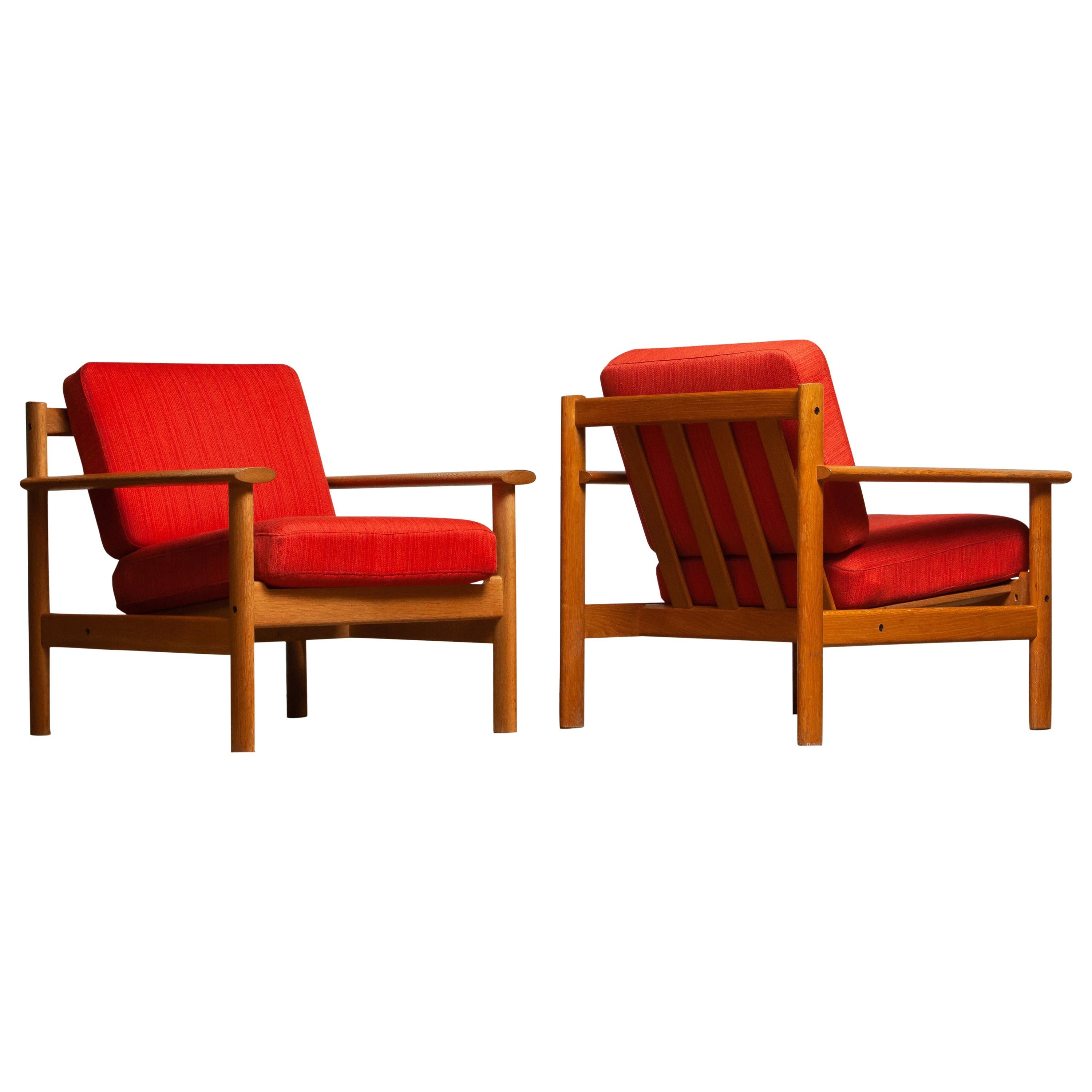 Firm set of two Danish oak lounge easy chairs in the manner of Poul Volther from the 1960s.
The cushions are a metal base with spring and still upholstered with the original fabric.
Overall condition is good.
 