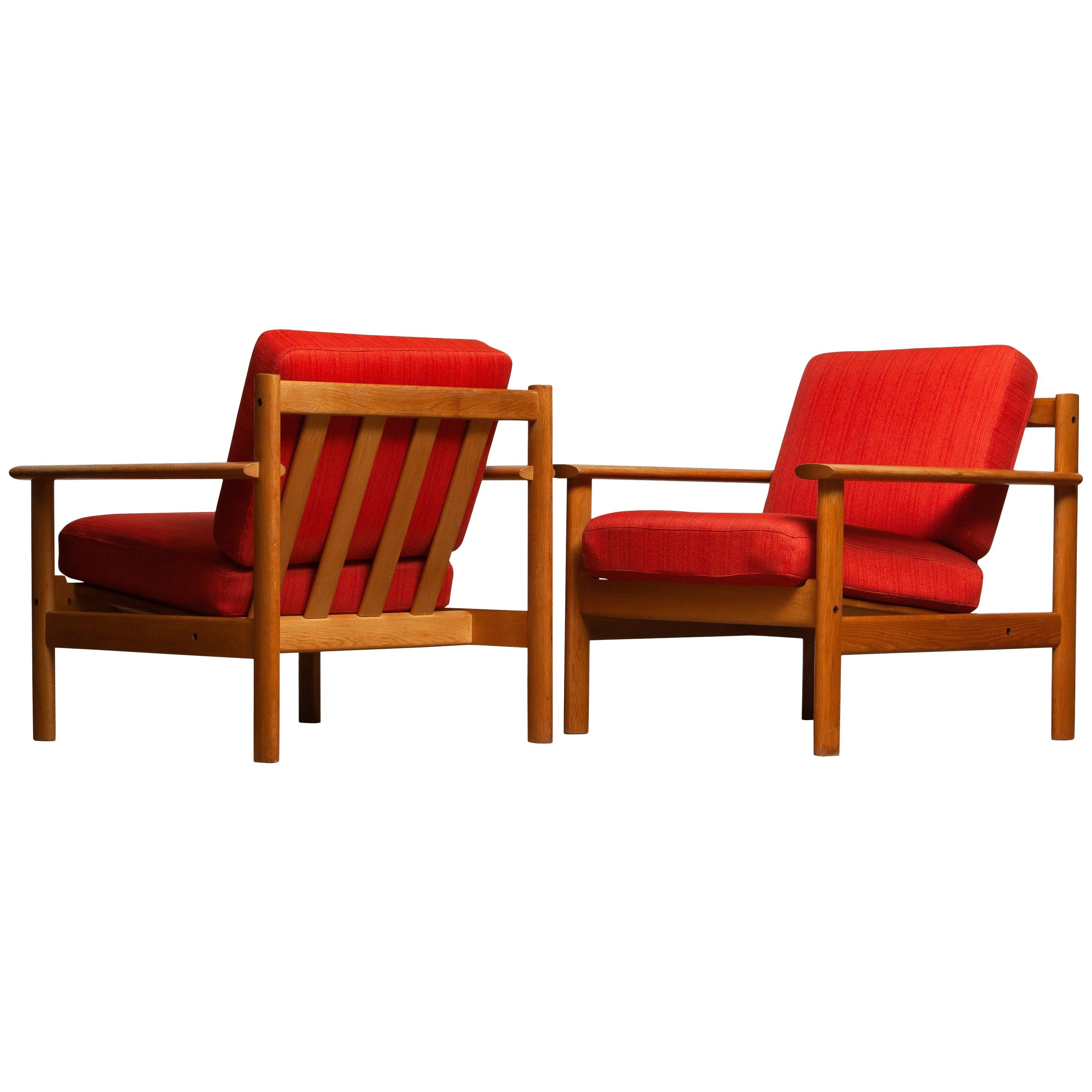 Firm set of two Danish oak lounge easy chairs in the manner of Poul Volther from the 1960s.
The cushions are a metal base with spring and still upholstered with the original fabric.
Overall condition is good.
 