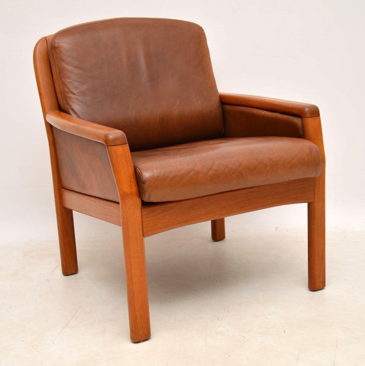 A stylish, top quality and very comfortable pair of vintage Danish armchairs, these were made by Dyrlund, they date from the 1960s-1970s. They are in very good condition for their age, the brown leather has a lovely patina, with some light surface
