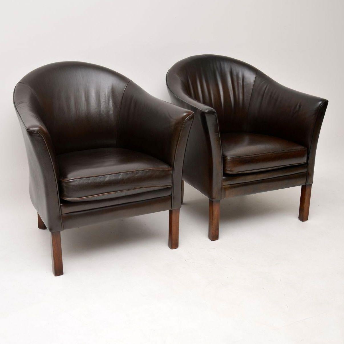 A stunning pair of vintage Danish armchairs made by Mogens Hansen, dating from the 1960s. They are in great condition for their age, the leather has been hand colored and revived by our professional leather polisher. They have a beautiful patina,