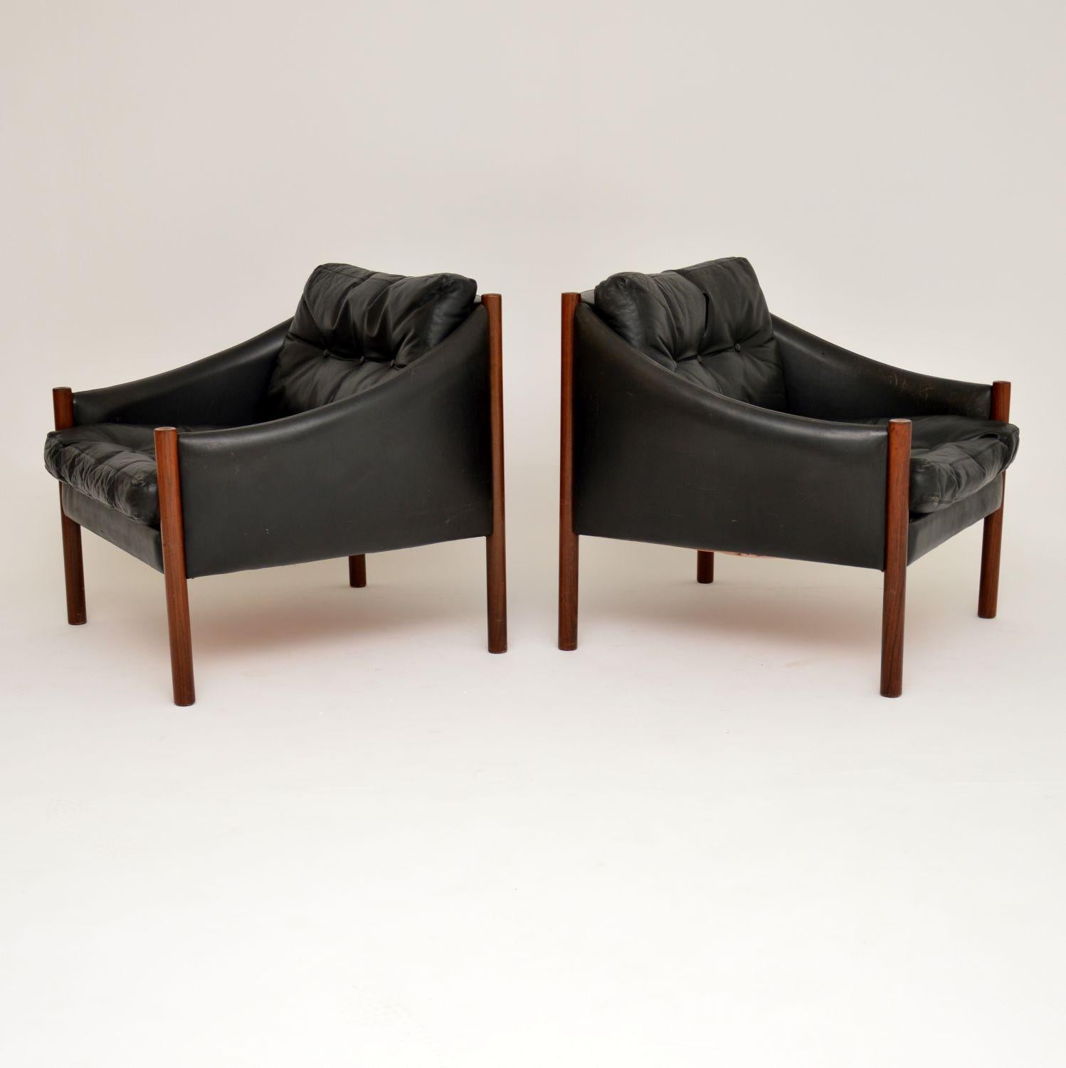 This stylish and extremely comfortable pair of armchairs were made in Denmark in the 1960s. They are beautifully made from black leather and solid wood, the quality is outstanding. They are in lovely vintage condition, the black leather is thick and
