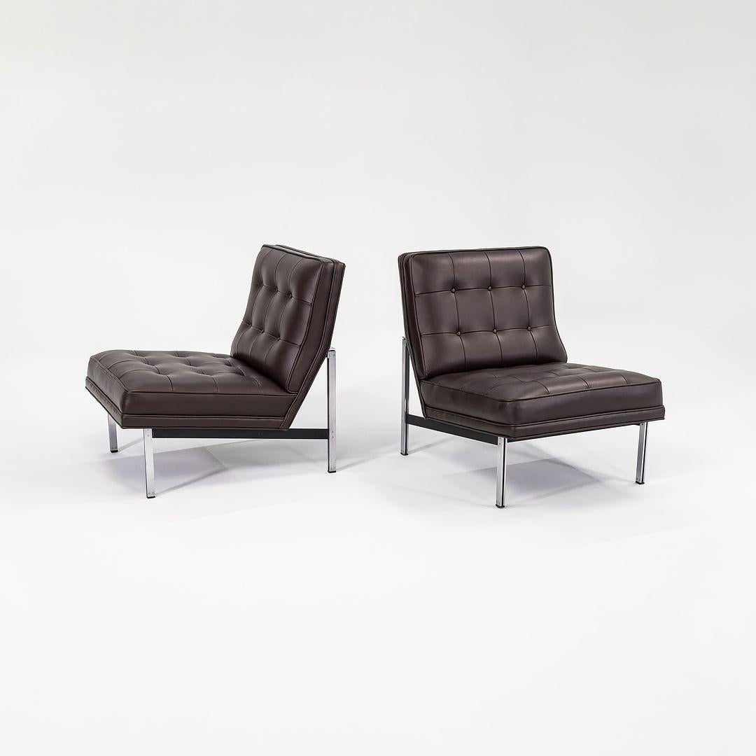 This is a pair of Florence Knoll Parallel Bar System Armless Slipper Lounge Chairs, Model 51, originally designed by Florence Knoll in 1955. These examples date to the 1960s and have been freshly redone in a dark brown Maharam Bask leather. The