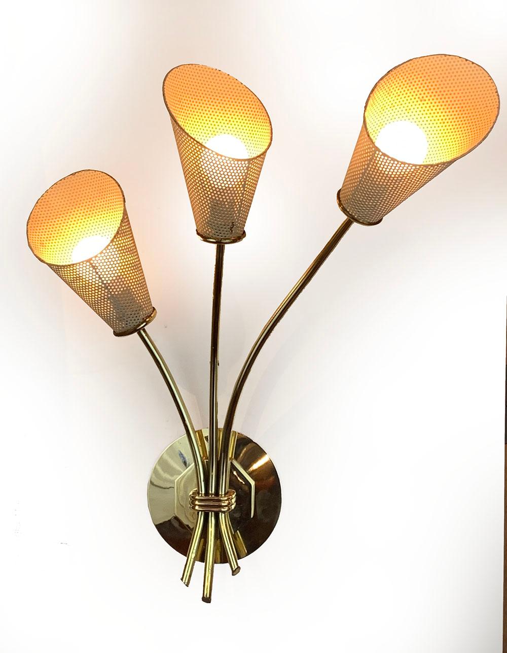 Pair of superb French Mid-Century Modern three light sconces, in brass and white lacquered perforated sheet metal or rigitule lampshades (in original condition), Attributed to Mathieu Mate´got, France c. 1960
Delivered and wired for American or