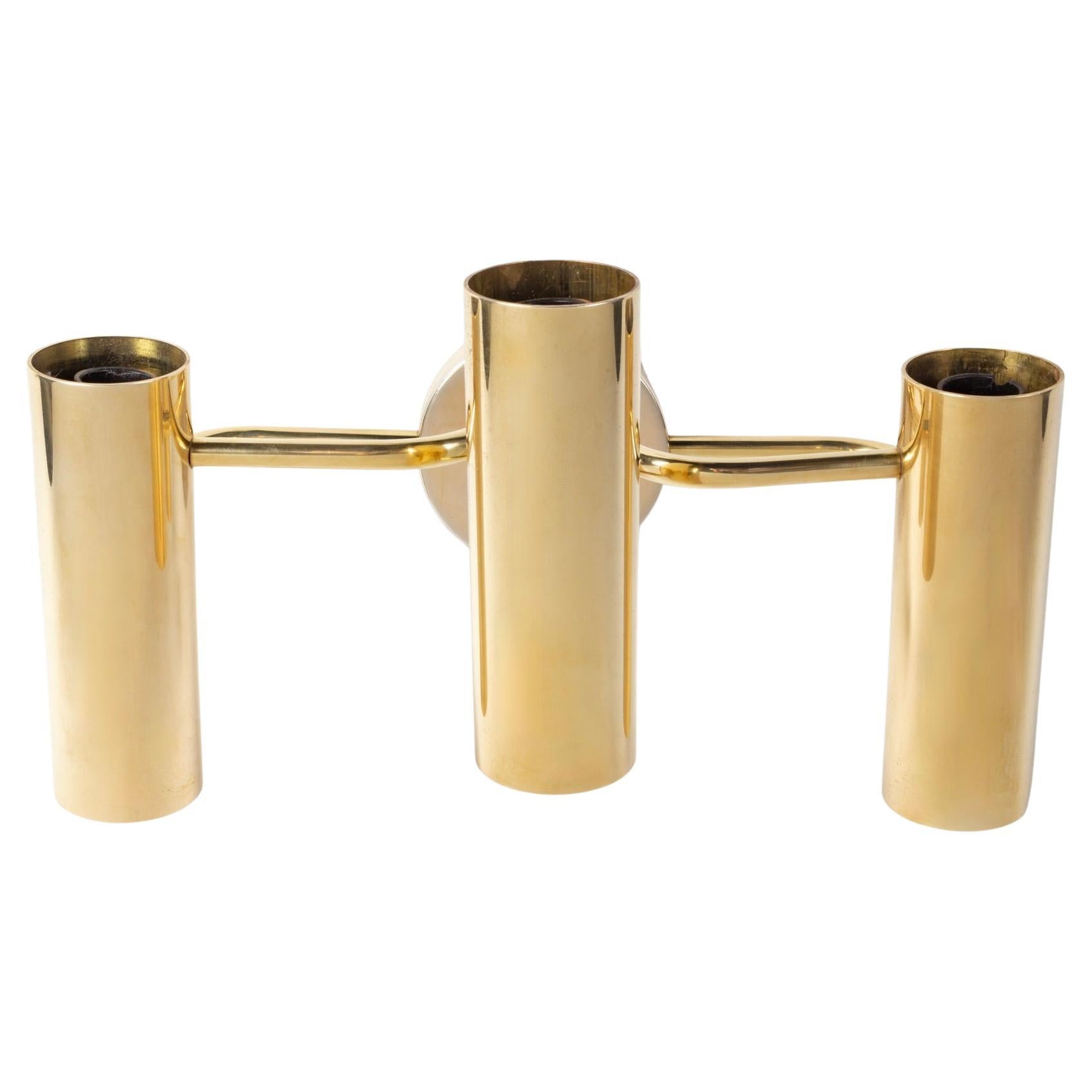 Pair of Gaetano Sciolari brass sconces from the 1960s.

The receptacles for three bulbs are made of three gilded brass cylinders positioned at two different heights and mounted on curved gilded brass rods meeting at the back on a round gilded brass