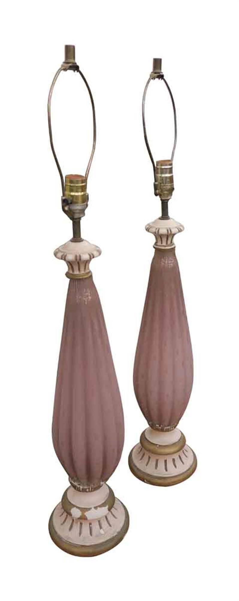 1960s handblown pink fluted Murano glass lamps on a carved and hand-painted wooden base. The lamps are electrified and ready to go. Priced as a pair. This can be viewed at one of our New York City locations. Please inquire for the exact address.
