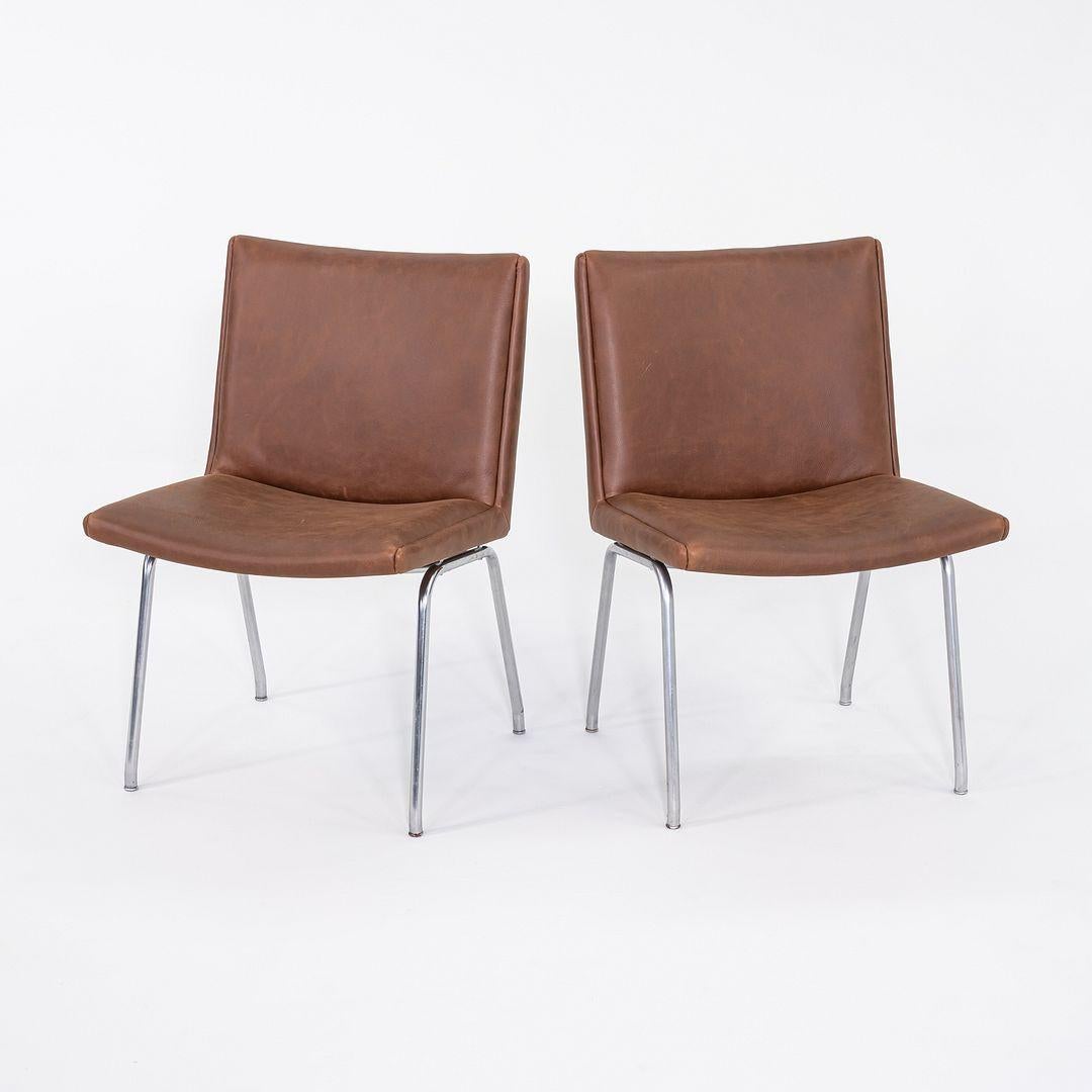 This is a pair of 'Airport' Chairs, Model AP38, designed by Hans J. Wegner for A.P. Stolen in 1958. The design is named after Copenhagen's Kastrup Airport, though it was not specifically designed for use there. The chairs have frames of stainless