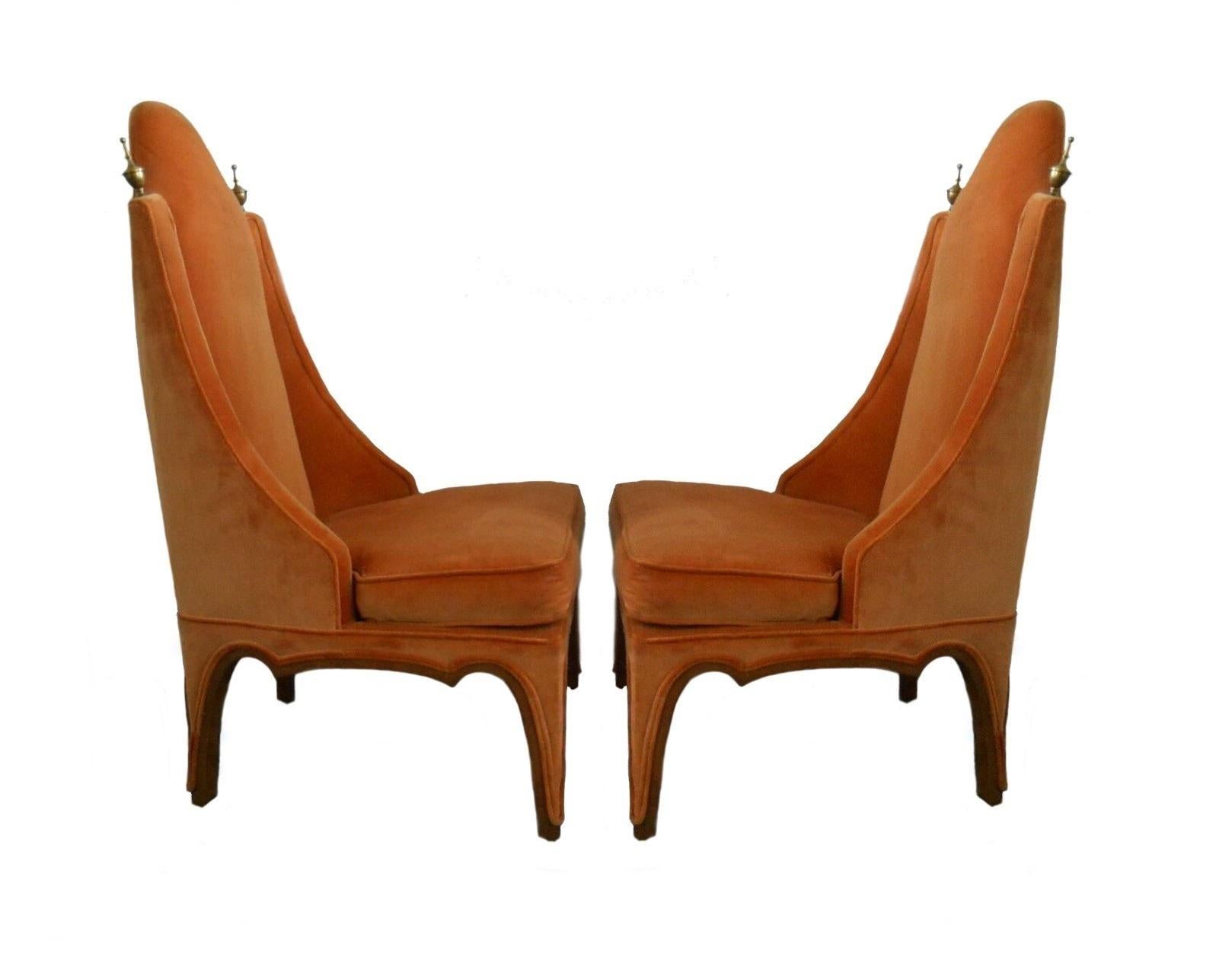 Unusually designed side or slipper chairs, American, 1960s. Newly upholstered in an orange velvet with the legs trimmed in walnut wood and accented by tall brass finials on top of each side of the chair back.