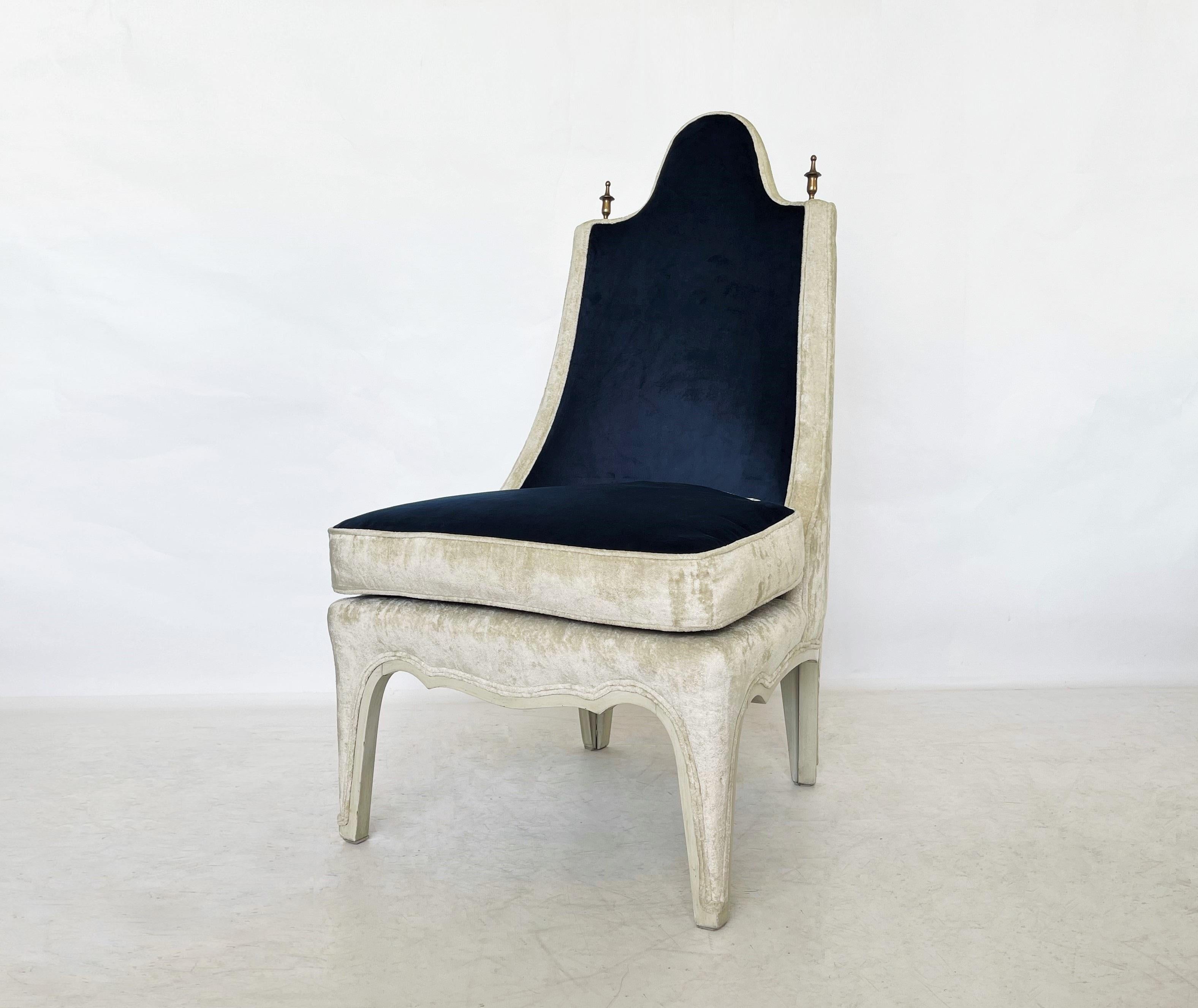 Unusually designed side or slipper chairs, American, 1960s. This stunning set has been recovered in a two-tone blue and cream colored velvet with the legs trimmed in painted wood and accented by tall brass finials on top of each side of the chair