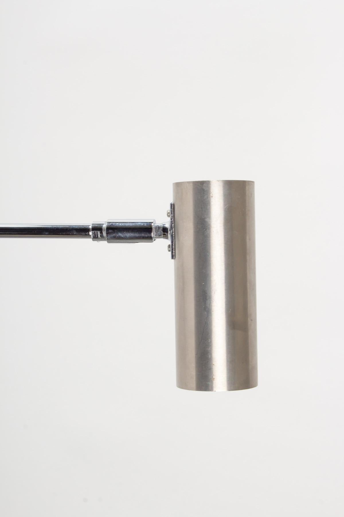Composed of a round wall support on which is placed a long rod ending with a rotating cylinder acting as a light source allowing to position it at your convenience, all in silver chrome. 
Designed in the 1960's by Jean Rene Caillette for the Pascot