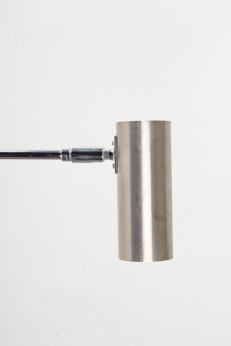 Composed of a round wall support on which is placed a long rod ending in a rotating cylinder acting as a light source, allowing it to be positioned as required, all in silver chromed steel. 
Designed in the 1960s by Jean René Caillette for the