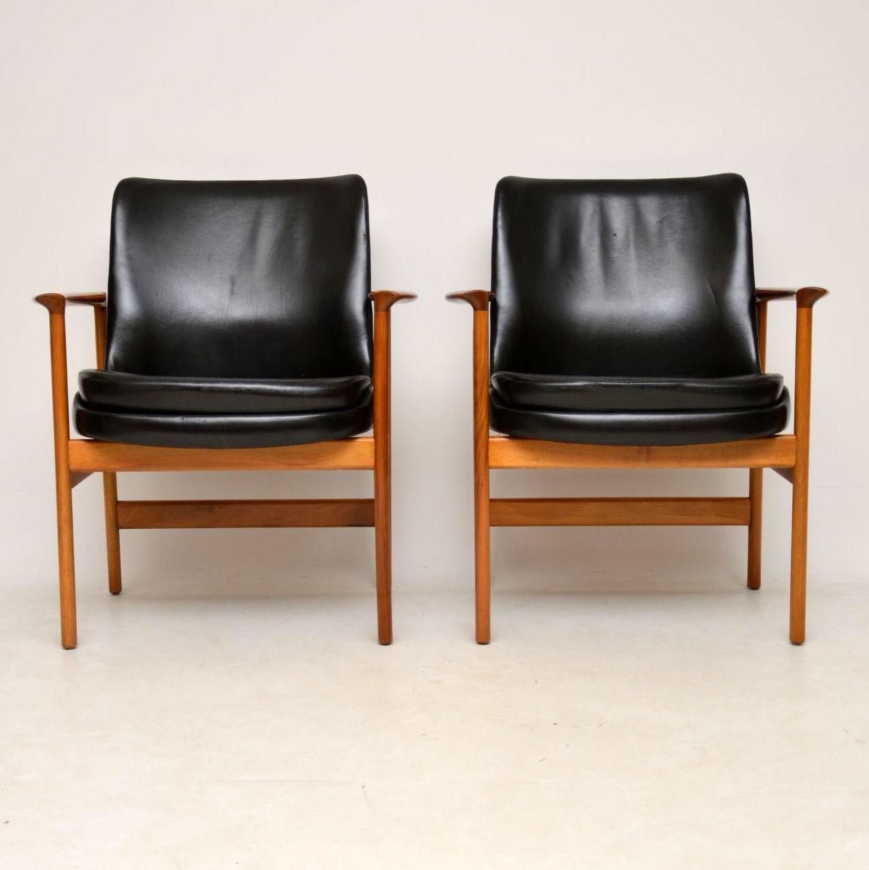 A stunning pair of vintage armchairs in walnut and leather, these were designed by the famous Danish designer IB Kofod Larsen for Froscher, they were made in the 1960s-1970s. The condition is great for their age, we have had the walnut frames fully