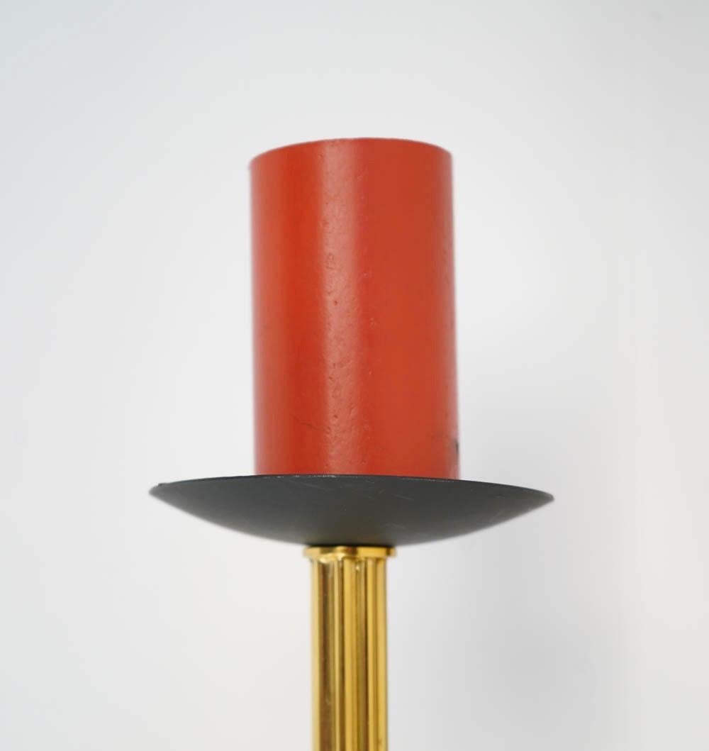 Each sconce consists of rectangular blackened backplate, a brass arms with a ribbed stem. 
The bulb socket is red lacquered highlighted with a black cup.
One bulb per sconces.
 