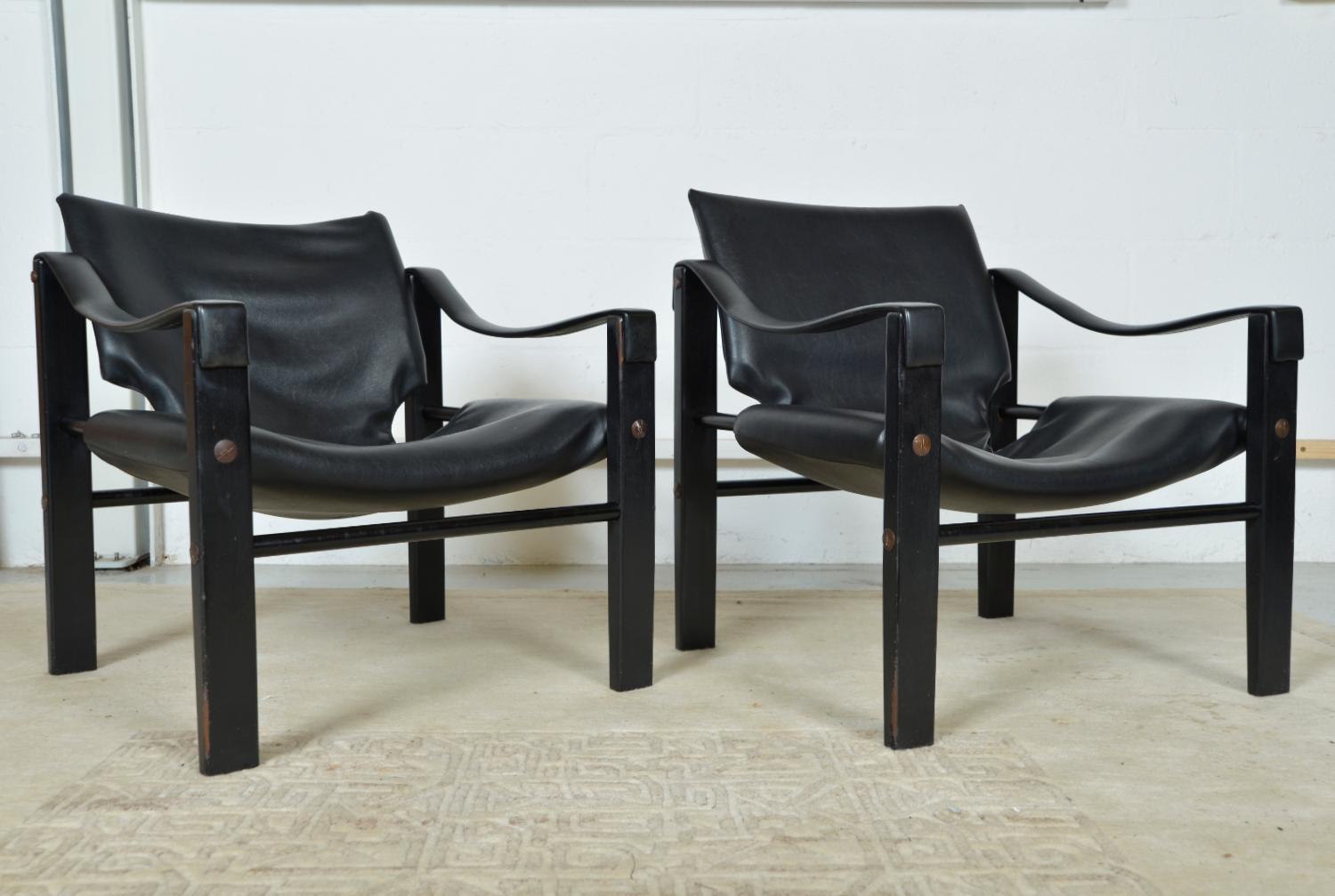 These stunning Safari sling lounge chairs, are early examples of the “Chelsea” model, designed by Maurice Burke in the 1960s for Arkana. The heavy black Naugahyde (faux leather), is soft and in great original condition, accented with over-sized