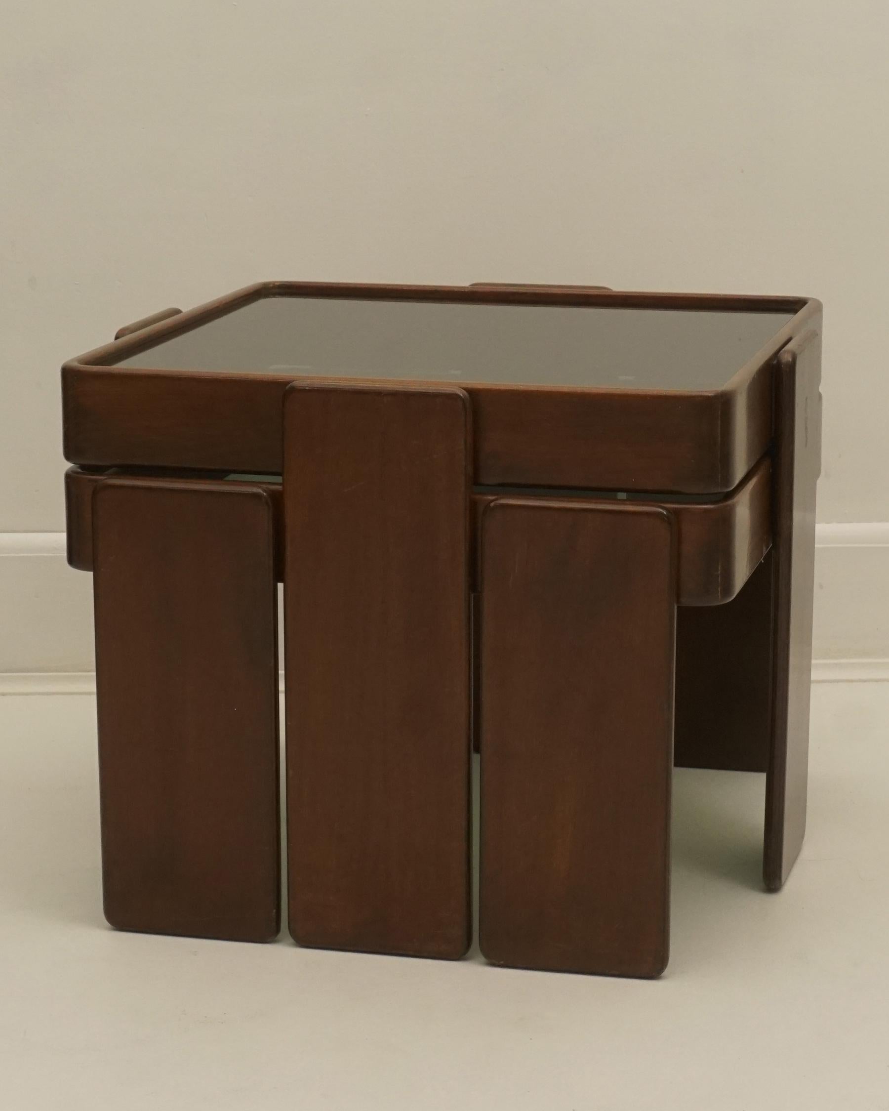 1960s stacking tables by Gianfranco Frattini for Cassina. Made in Italy. The two tables are stackable to create a square block. Wood with smoked glass. In good used vintage condition, some scuffs, small nicks, and signs of age and use. Sold as set