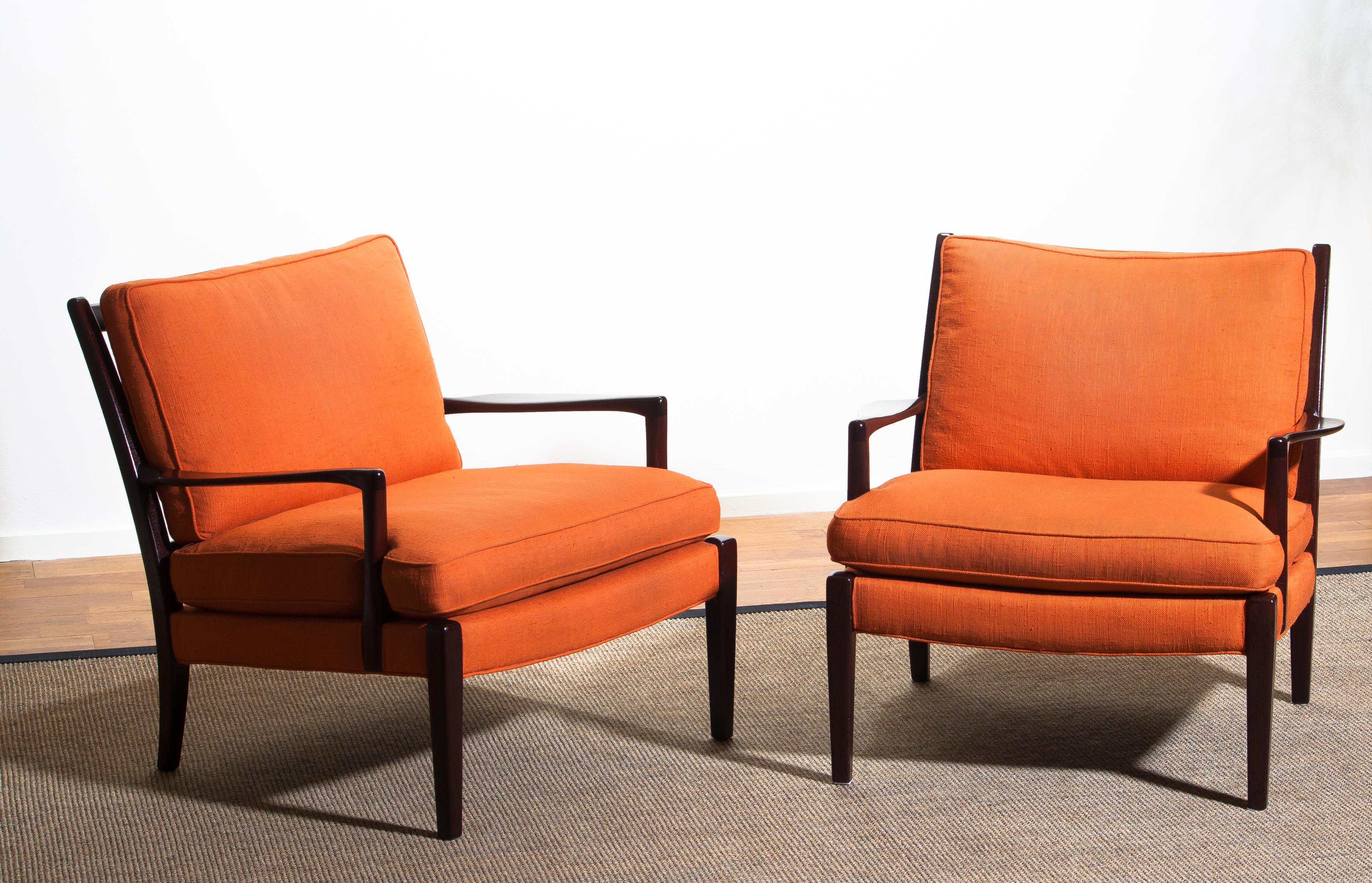 Beautiful set of two original orange colored linen easy / lounge chairs, model 