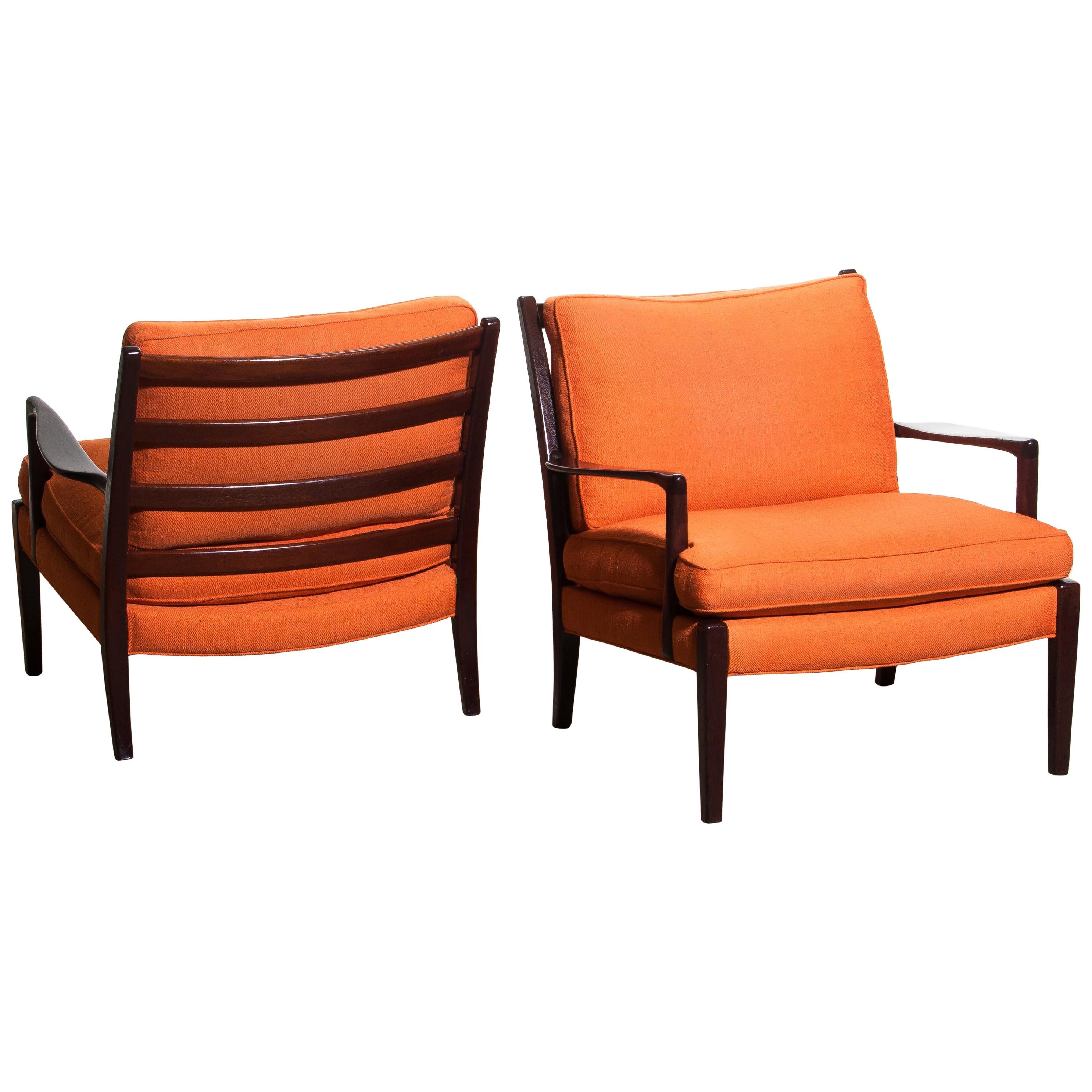 Beautiful set of two original orange colored linen easy / lounge chairs, model 