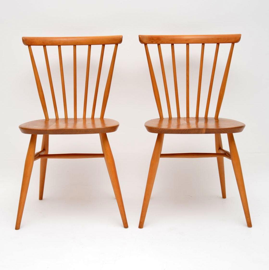 A top quality and very stylish pair of vintage side chairs by Ercol, these date from the 1960s-1970s. They are in superb condition for their age, with only some extremely minor wear here and there. They are clean sturdy and sound, with stunning