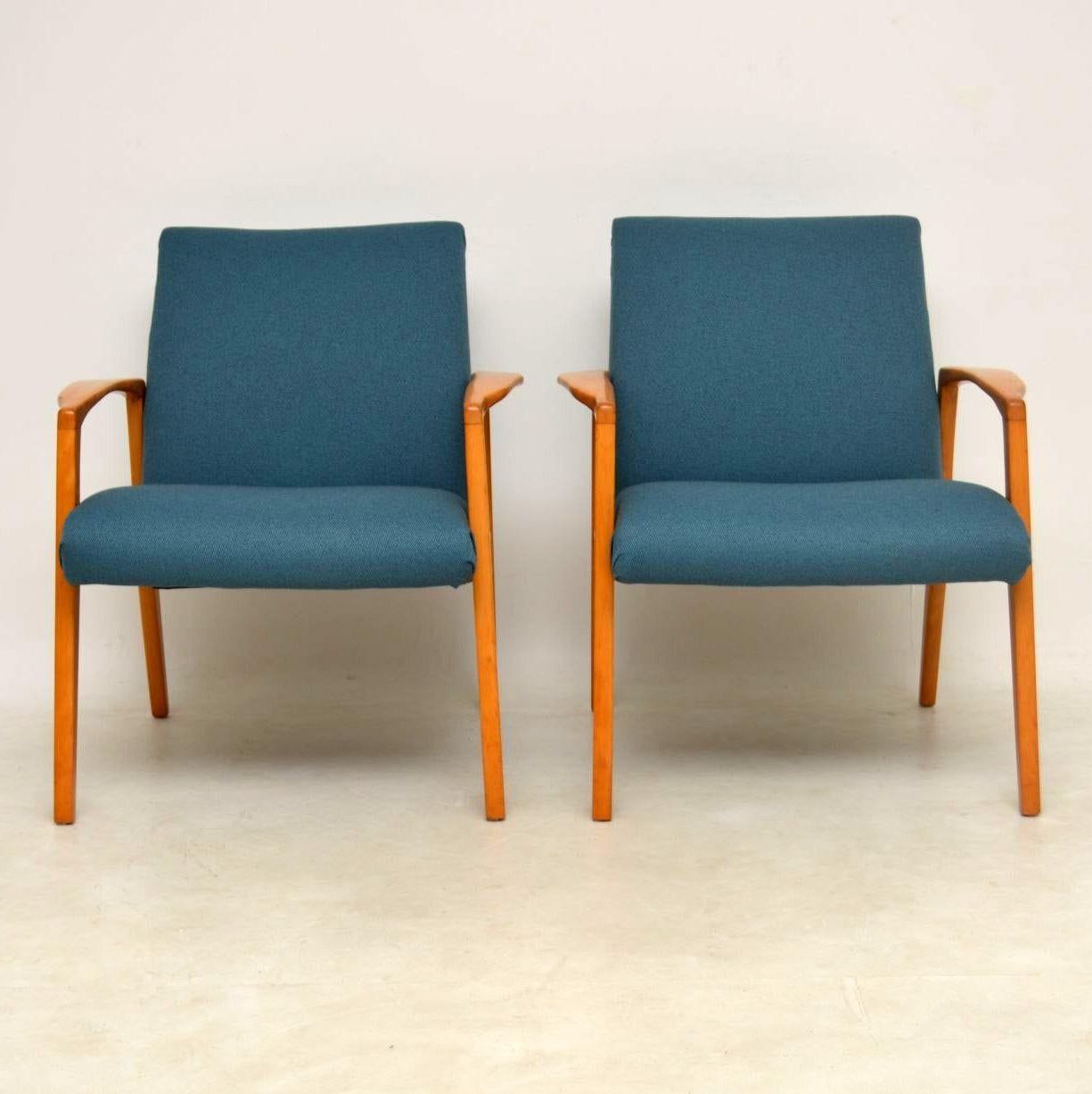 A beautiful pair of vintage armchairs, these were recently imported from Sweden and they date from the 1960s. The frames are a solid light wood, possibly cherry or beech, and the condition is excellent for their age. There is just some minor wear