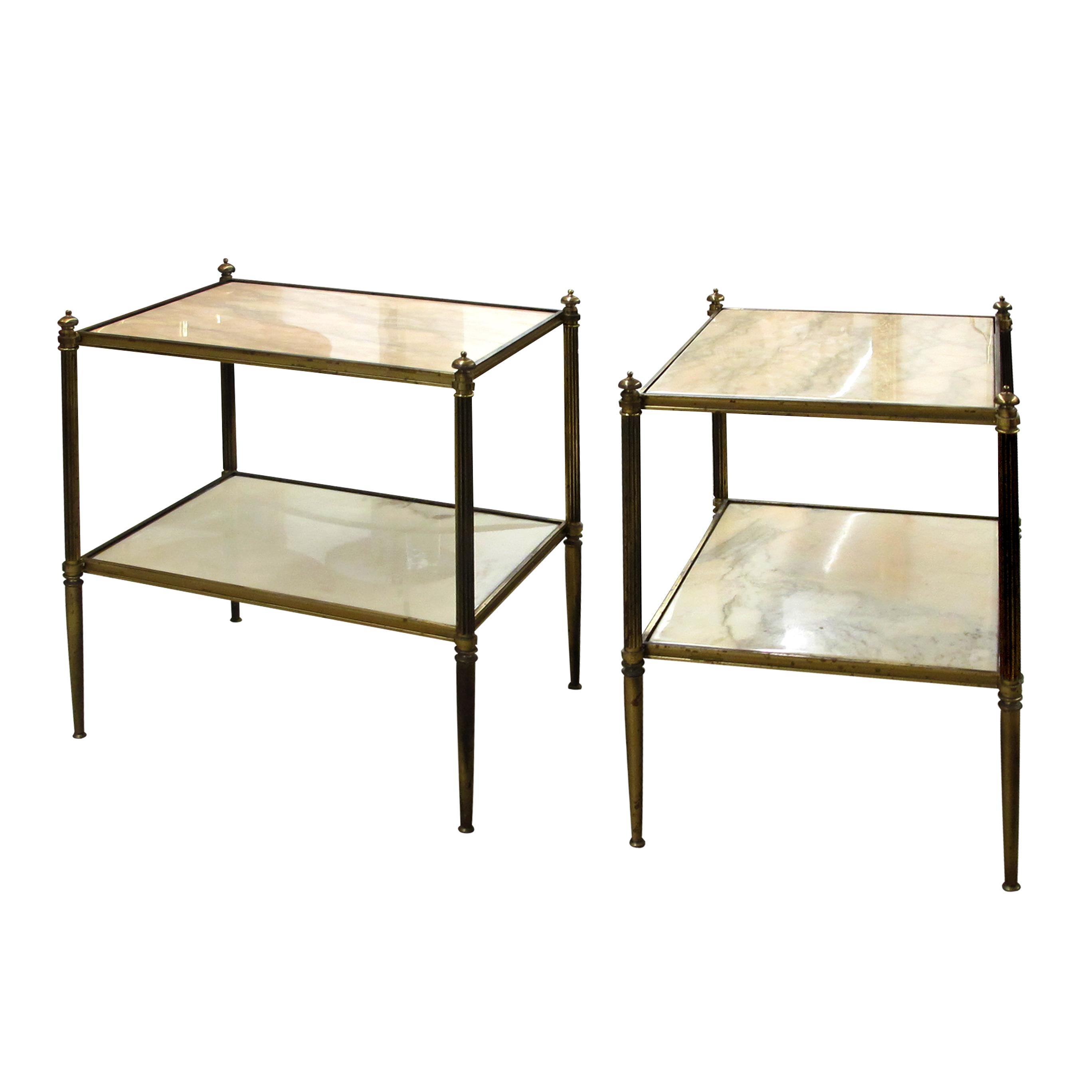 The defining feature of these French side tables lies in their architectural brass frames in the style of Maison Bagues aesthetic that flourished during the 1960s. The two-tier design allows for both form and function to coexist harmoniously. The