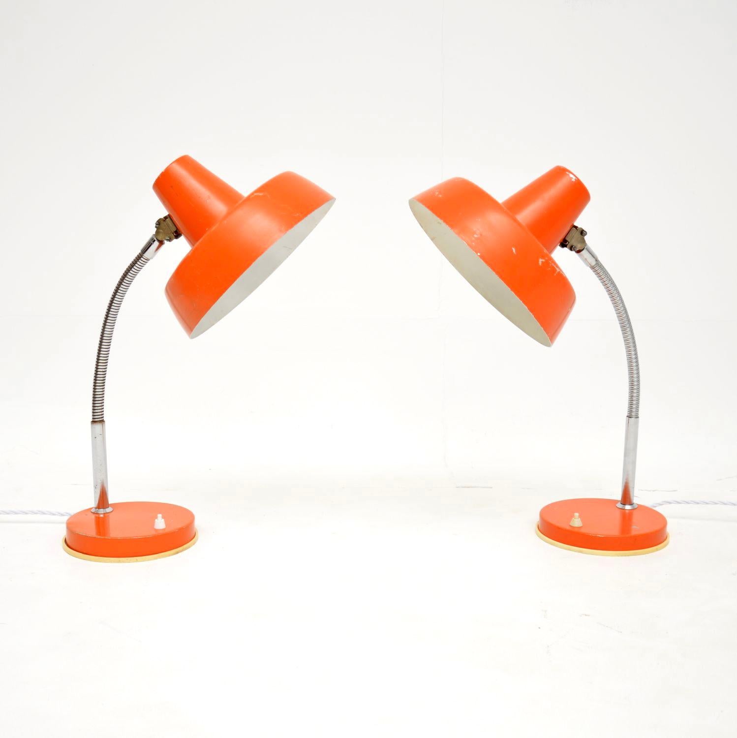 A superb pair of vintage table lamps, beautifully finished in orange. They were made in Germany, and they date from the 1960’s.

The quality is fantastic, these are very useful and could be used as desk lamps, or even as bedside lamps.

We have had