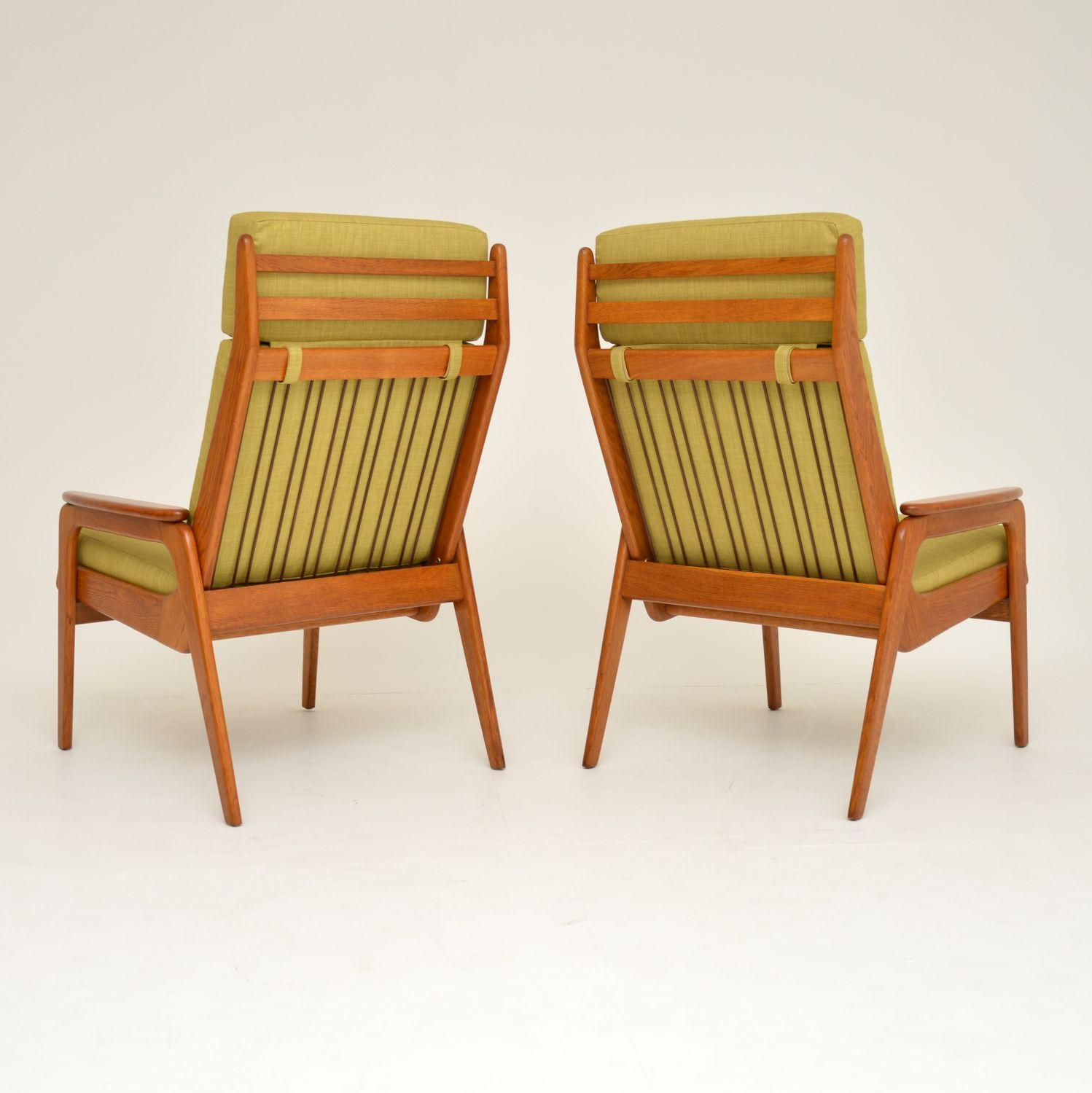 A beautiful pair of vintage armchairs, made in Holland in the 1960s. They are of amazing quality, with solid oak frames and solid teak armrests. These are extremely comfortable, and are in superb condition. We have had the frames fully stripped and
