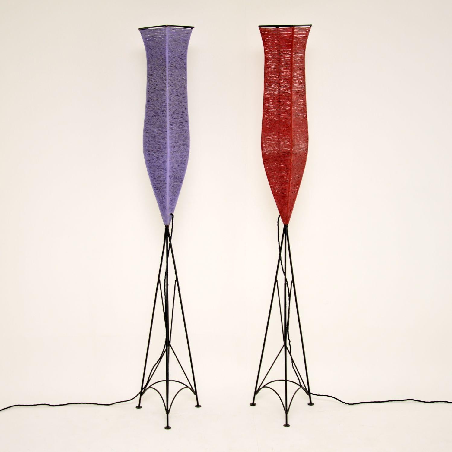 This is a very unusual and stylish pair of vintage floor lamps, dating from circa 1960s. They are made with black painted steel frames, and shades that have been spun from a tough and colorful material. The result is very striking and beautiful.