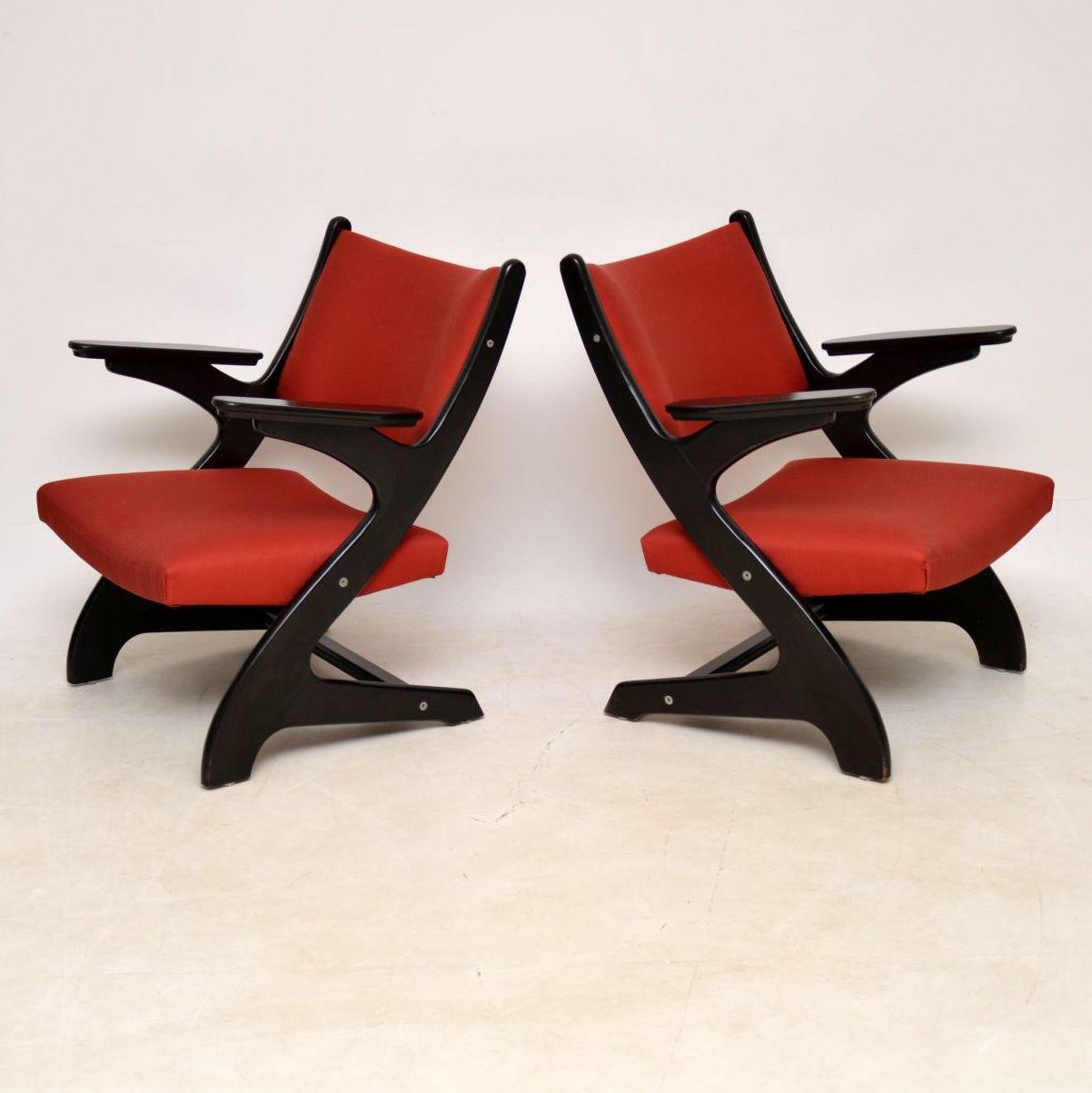 A very stylish and extremely comfortable pair of vintage Italian armchairs, these date from circa 1960s-1970s. They have a stunning shape, with ebonized wood frames, the condition is very good for their age. The frames are all clean, sturdy and