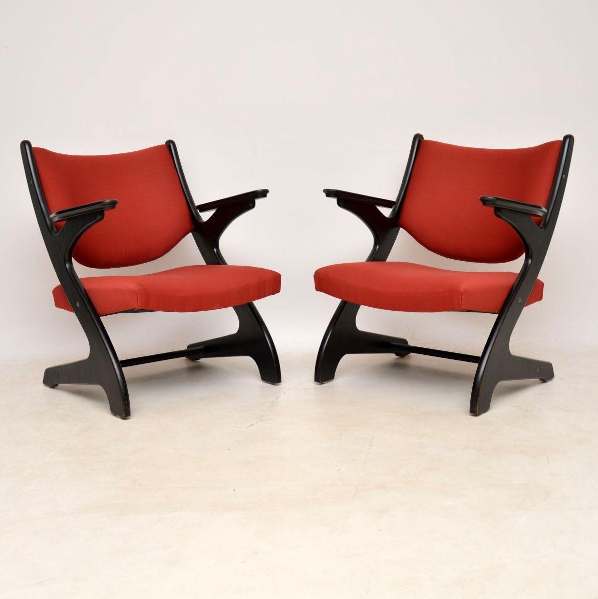 A very stylish and extremely comfortable pair of vintage Italian armchairs, these date from circa 1960s-1970s. They have a stunning shape, with ebonized wood frames, the condition is very good for their age. The frames are all clean, sturdy and