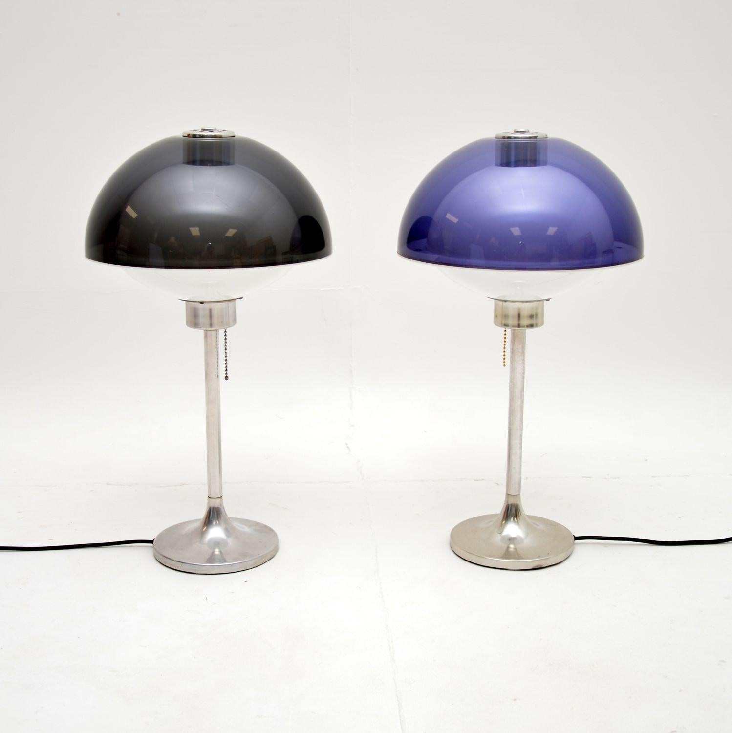 A stunning and very rare pair of vintage “Lumitron” table lamps. They were designed by Robert Welch, they were made in England and date from the 1960’s.

They have a fantastic space age design, with beautiful tinted plastic domed shades, sitting on
