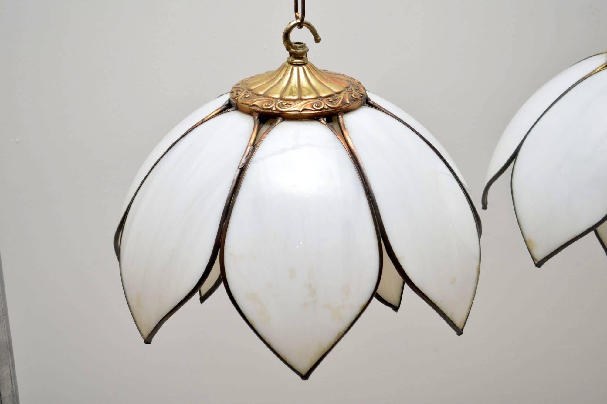 A beautifully made pair of vintage pendant lamps, these were made in London in the 1960s. They are of amazing quality, we’re not completely sure of the material but it looks like a type of white resin and gilt metal. The condition is excellent for