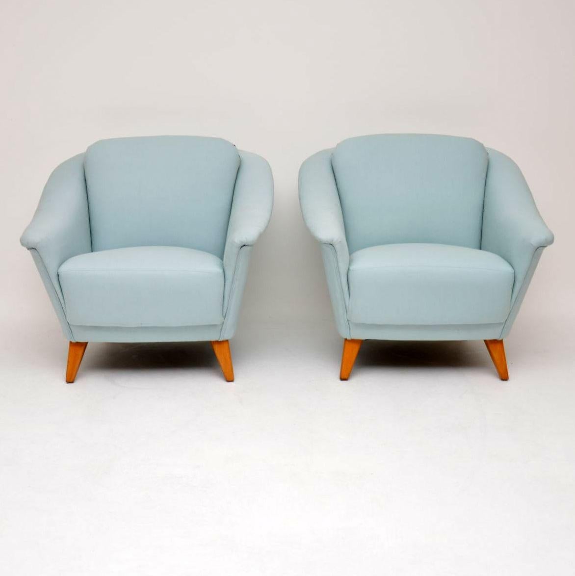 An absolutely beautiful and really well made pair of vintage armchairs from the 1960s, these were made in Sweden. We have had them fully upholstered in a lovely light blue fabric, the legs have also been fully stripped and re-polished, so the